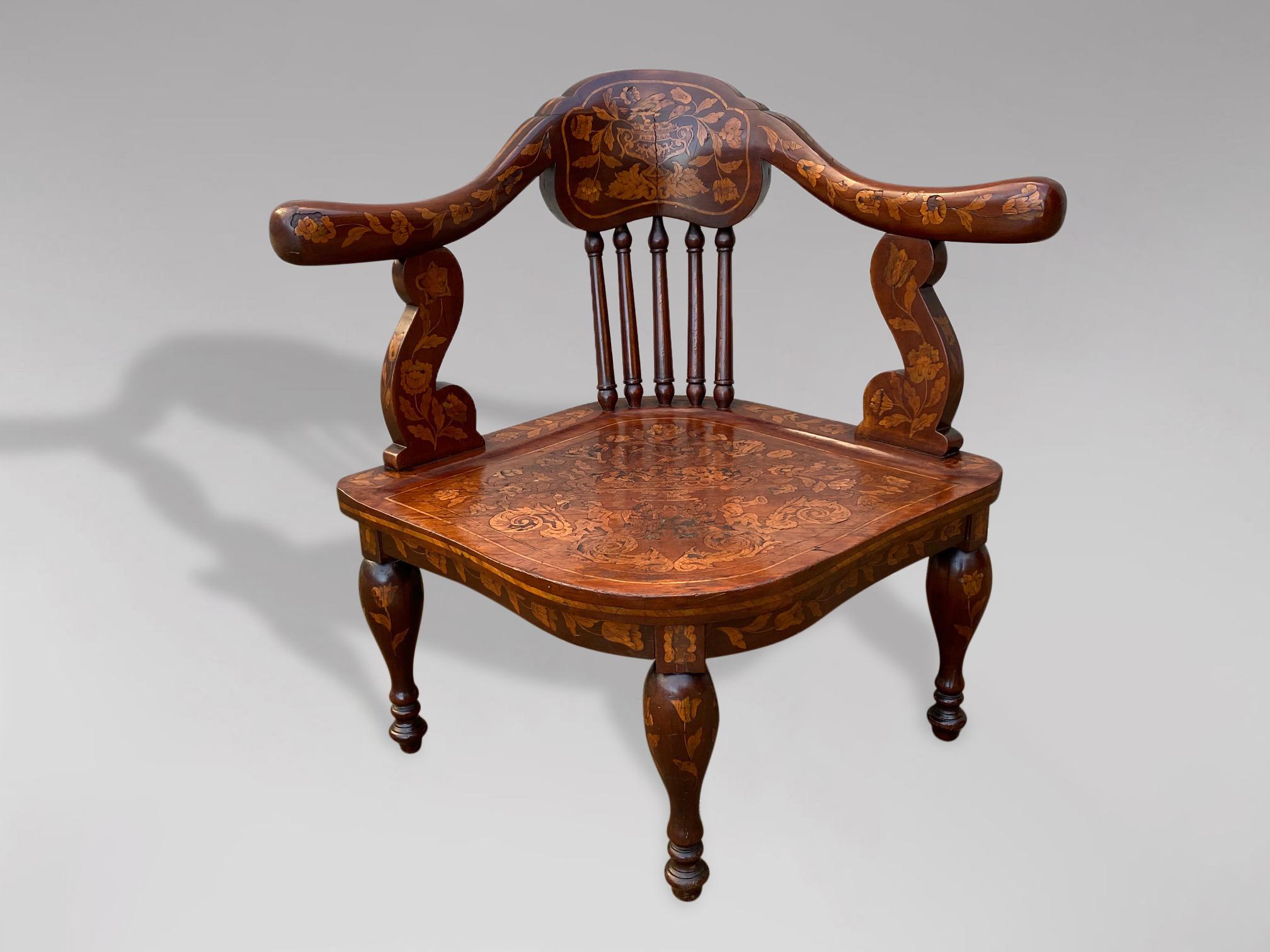 An 18th century, Dutch mahogany and marquetry corner chair. The shaped top rail supported by baluster turned supports, with a lovely elaborate marquetry seat raised on three turned baluster legs and a splayed back leg. This corner chair has been