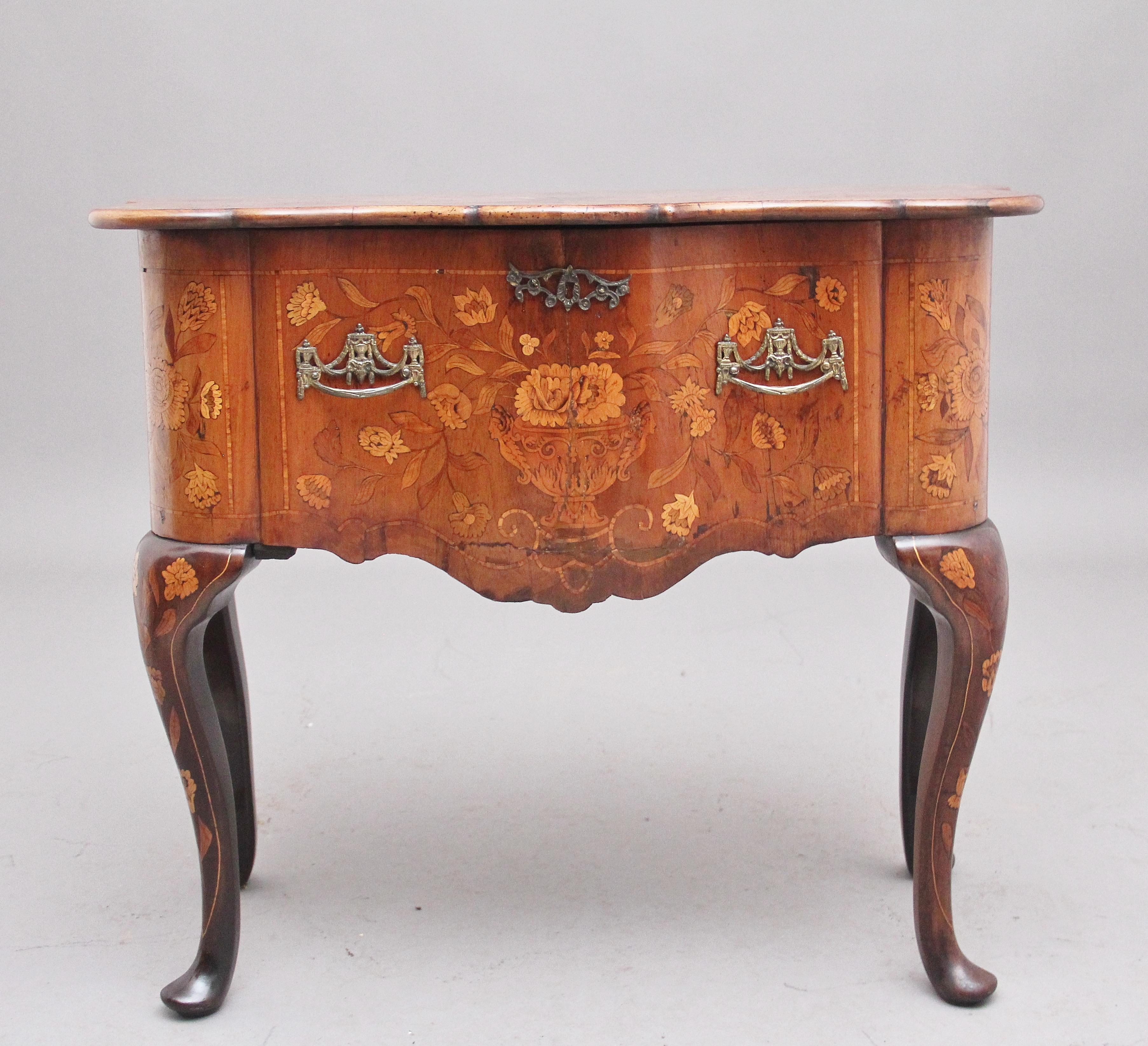 A lovely quality 18th century Dutch marquetry walnut side table, profusely inlaid all over with decorative floral marquetry inlay, the shaped hinged top opening up and flipping over and resting on the rear leg which folds round, opening to reveal