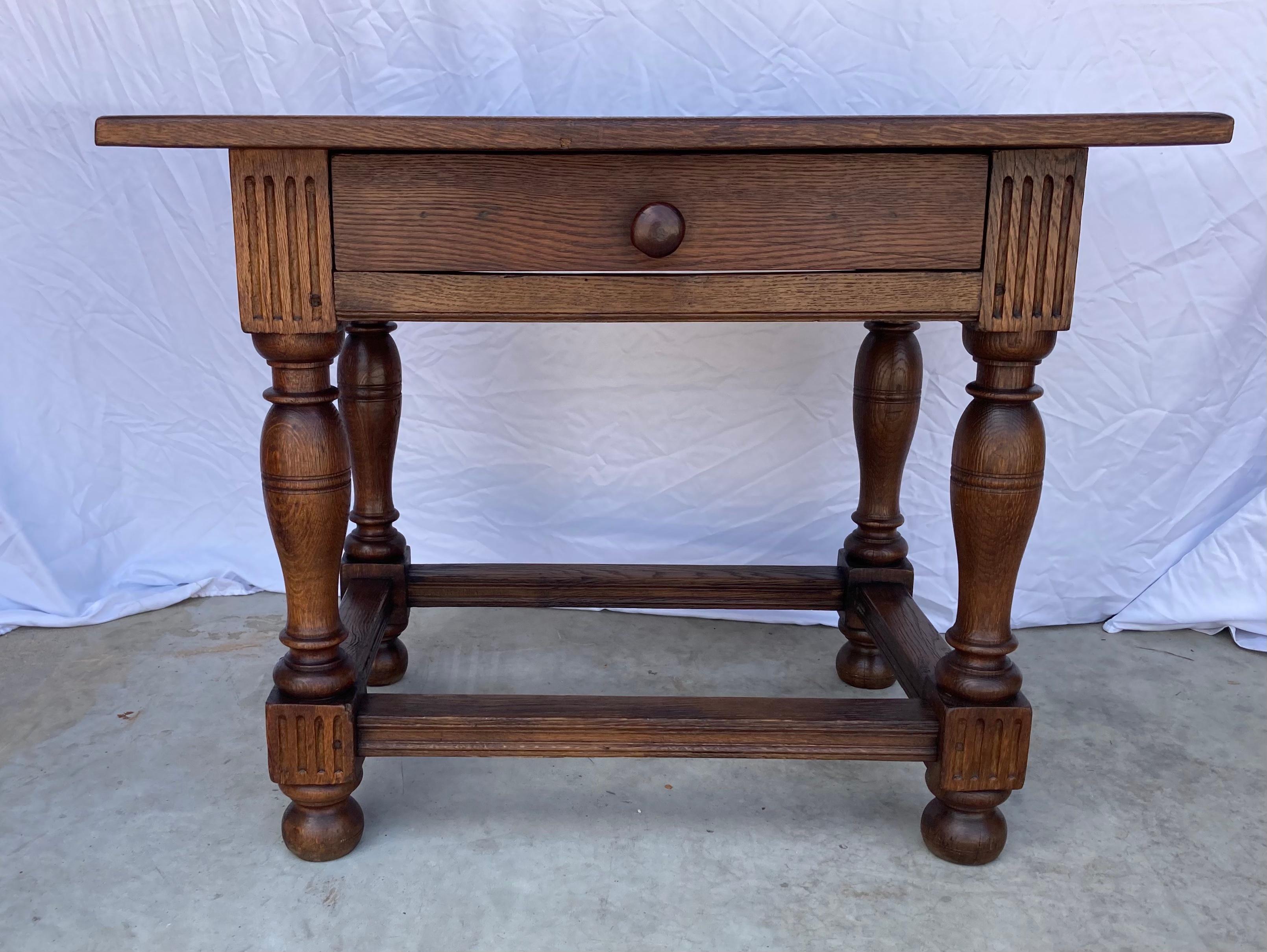 Rectangular side table built using oak and pegged construction in the late 1700s in the Netherlands. This table shows beautiful craftsmanship and proportions. The top features an inset panel attached to the base with rose-head nails, and sits on a