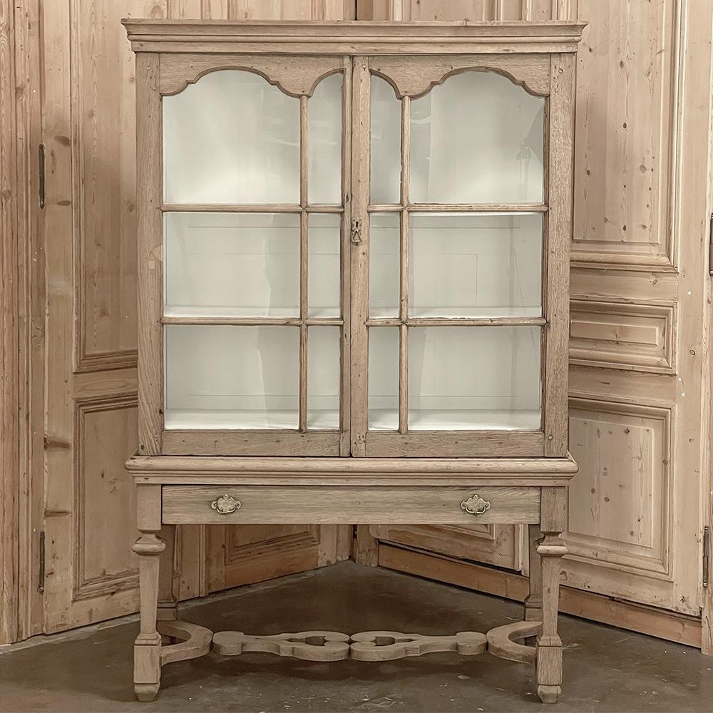 18th century Dutch Raised Cabinet ~ Bookcase in Stripped Oak combines stately lines with a casual presence that makes it versatile for a wide variety of decors! The stripped oak finish presents a soft texture and color while the interior display is