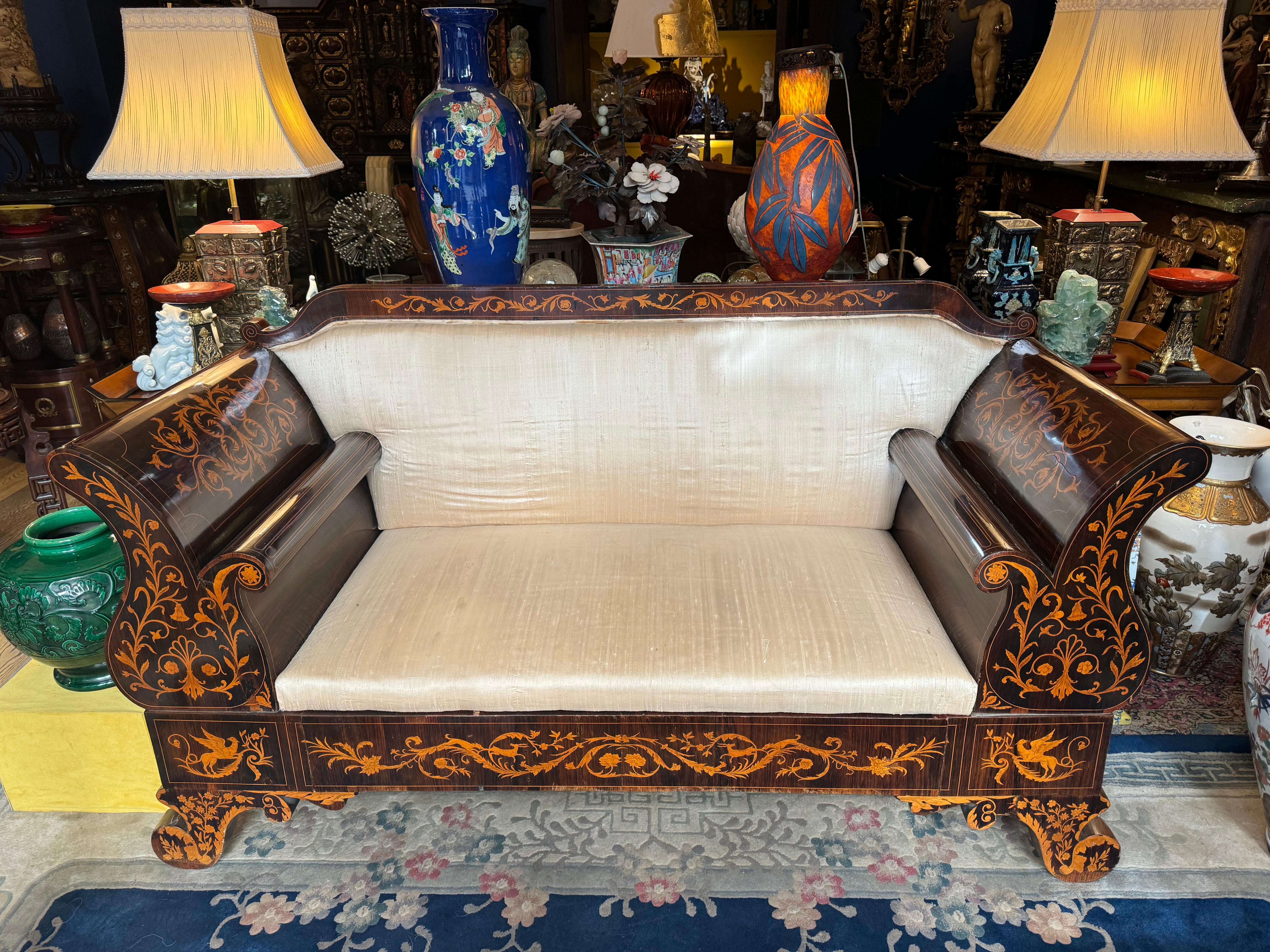 
In the opulent realm of 18th-century Dutch furniture, the rosewood sofa with intricate marquetry in fruitwood stands as an epitome of elegance and craftsmanship. Crafted during the height of the Dutch Golden Age, this sofa embodies the luxurious