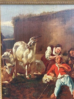 18th century Dutch, with figures goats and sheep outside in a barn yard or farm