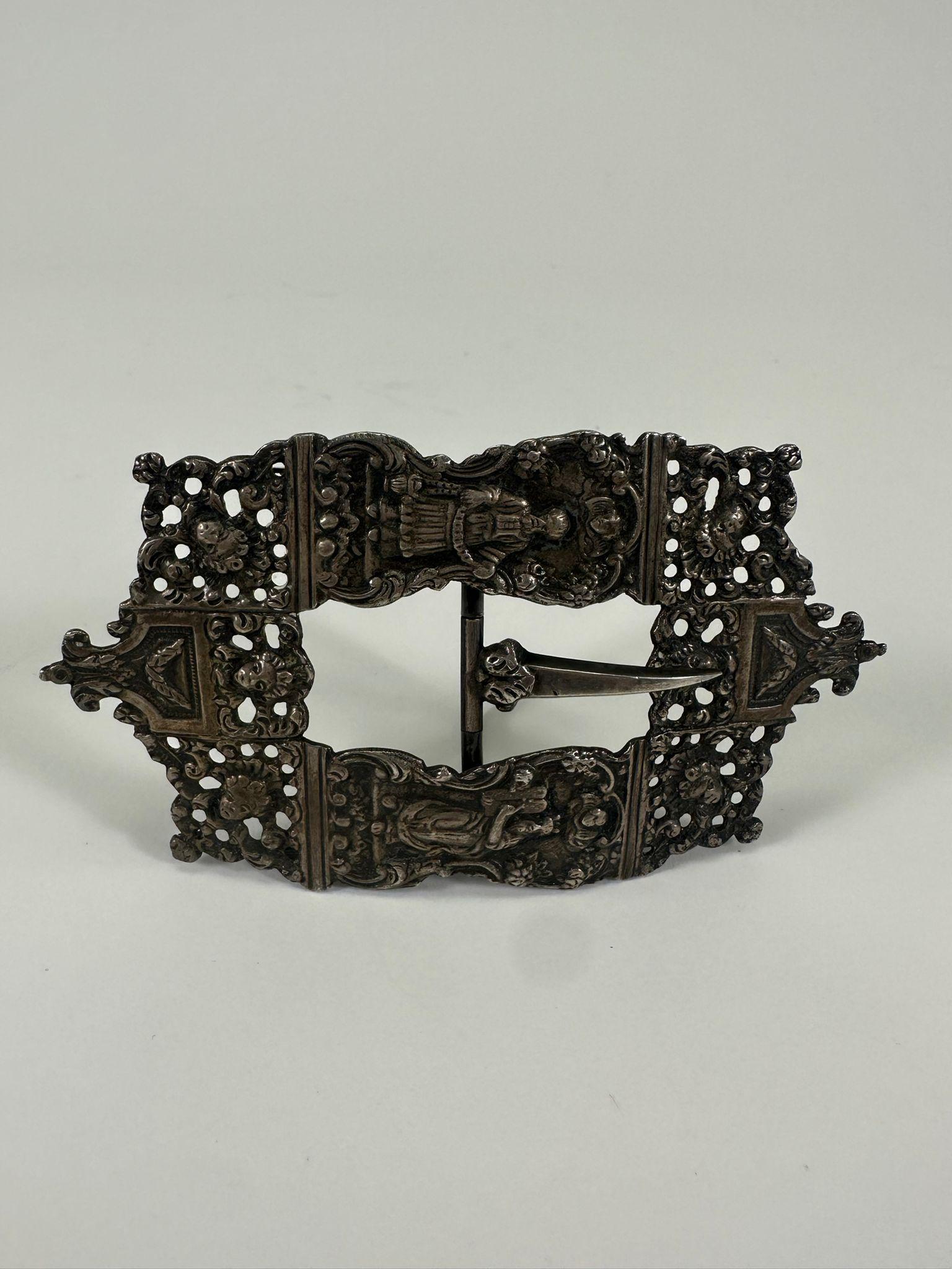 This rare and exquisite 18th-century silver belt buckle from the Netherlands was worn on Yom Kippur, secured with a cloth sash around the traditional kittel. It is a masterful example of Dutch Jewish silversmithing, with elaborate openwork and