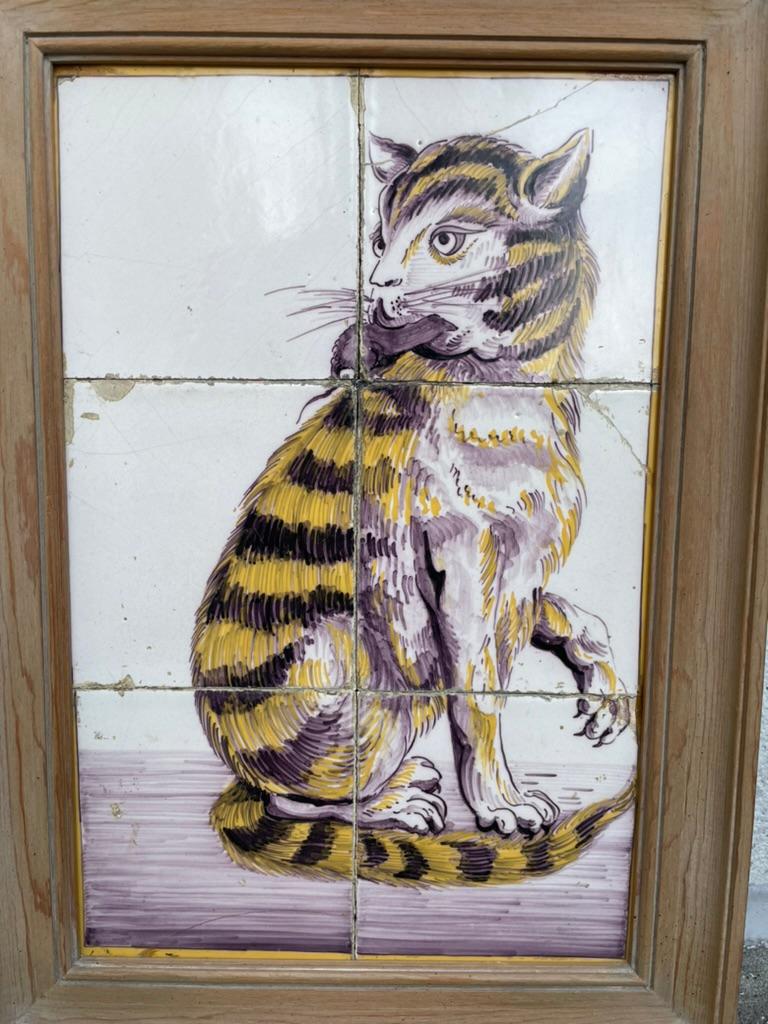 Wonderful Dutch 18th century tile painting of a cat with holding a mouse in it's mouth. Depicted right after the catch, with paw lifted showing exposed claws. The yellow and manganese striped cat looking confident ans self possessed, with the