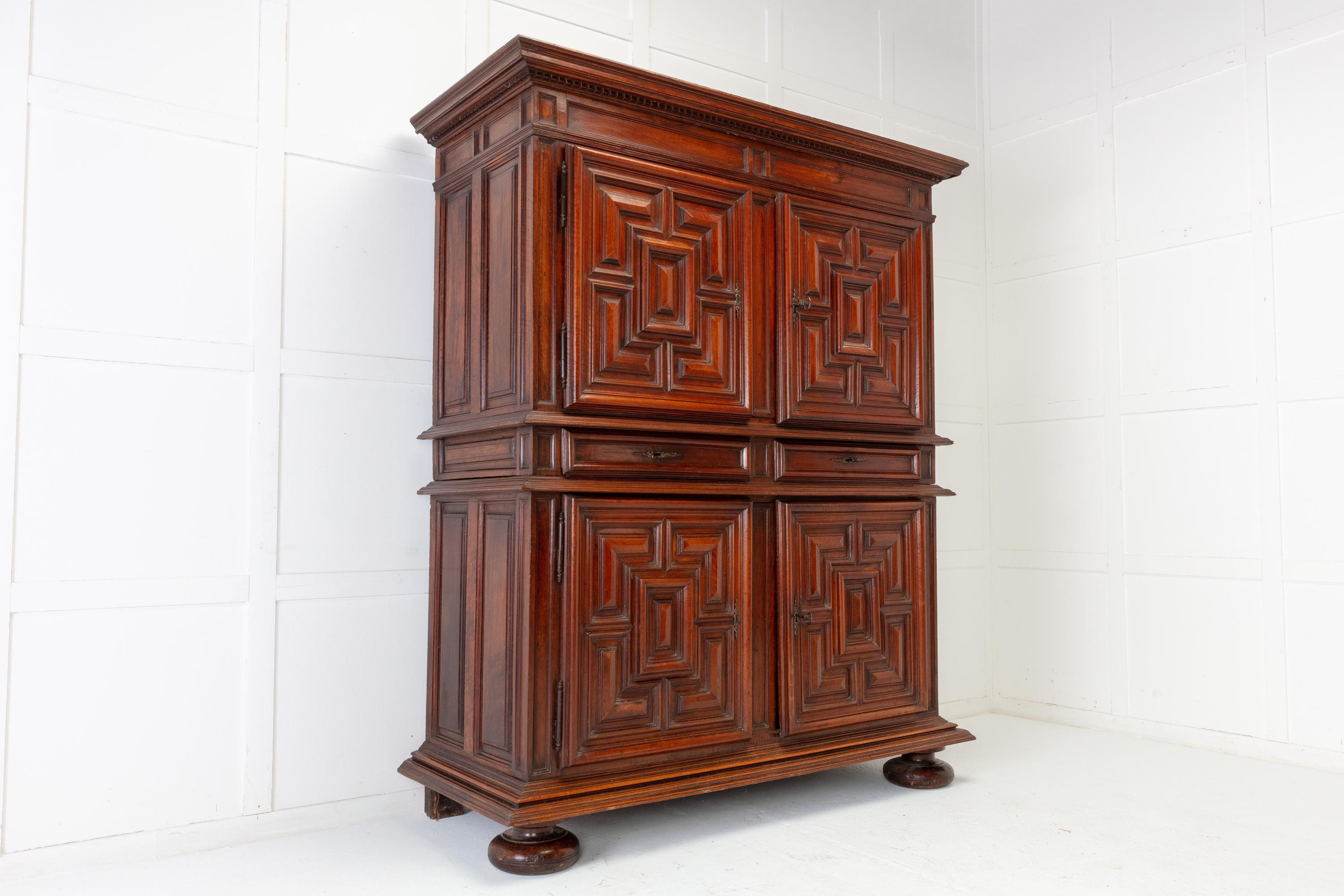 18th century Dutch walnut cabinet of substantial quality, having a shaped cornice with dentil carving. Four geometrically moulded panel doors giving it a nice balanced design, that open to reveal a large storage space. The sides are also heavily