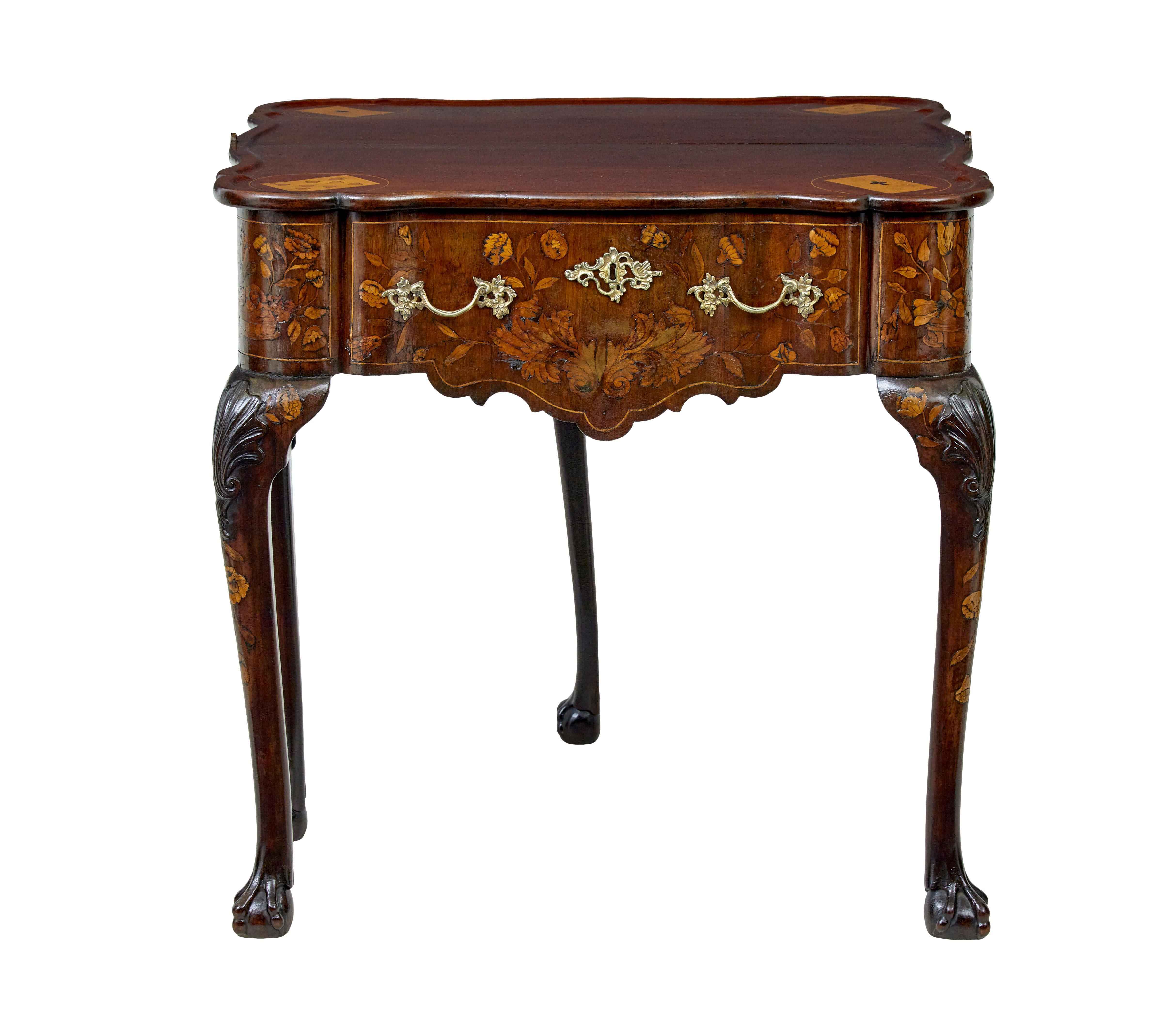 18th century Dutch walnut flip top games table circa 1800.

Shaped top in a reverse serpentine form, beautifully inlaid with a central urn, scrolling acanthus, surrounded by flowers & foliate and birds. Flip top opens to an elegant mahogany top,