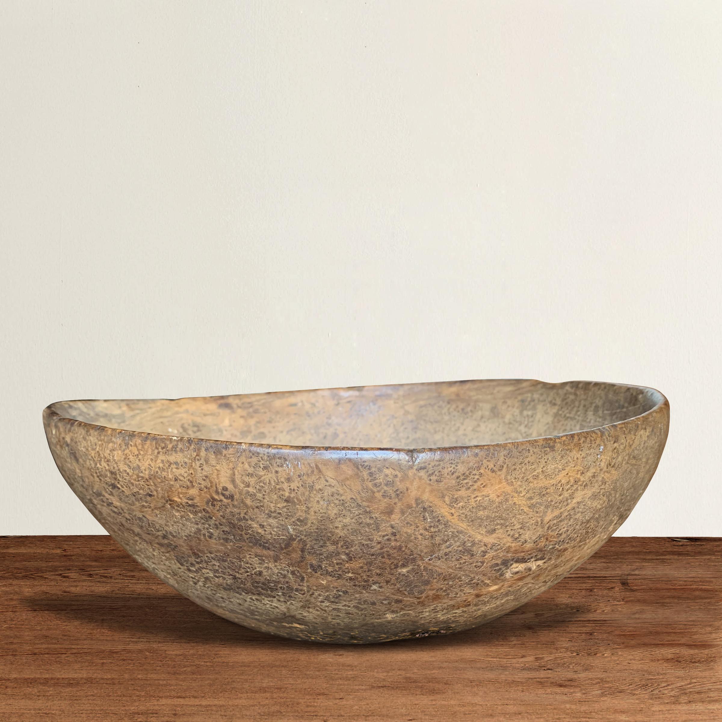 An incredible 18th century early American ash burl bowl from New England, probably New York, with an extraordinary tight burl grain pattern and a smooth surface with a well-worn patina, the result of over two centuries of use.