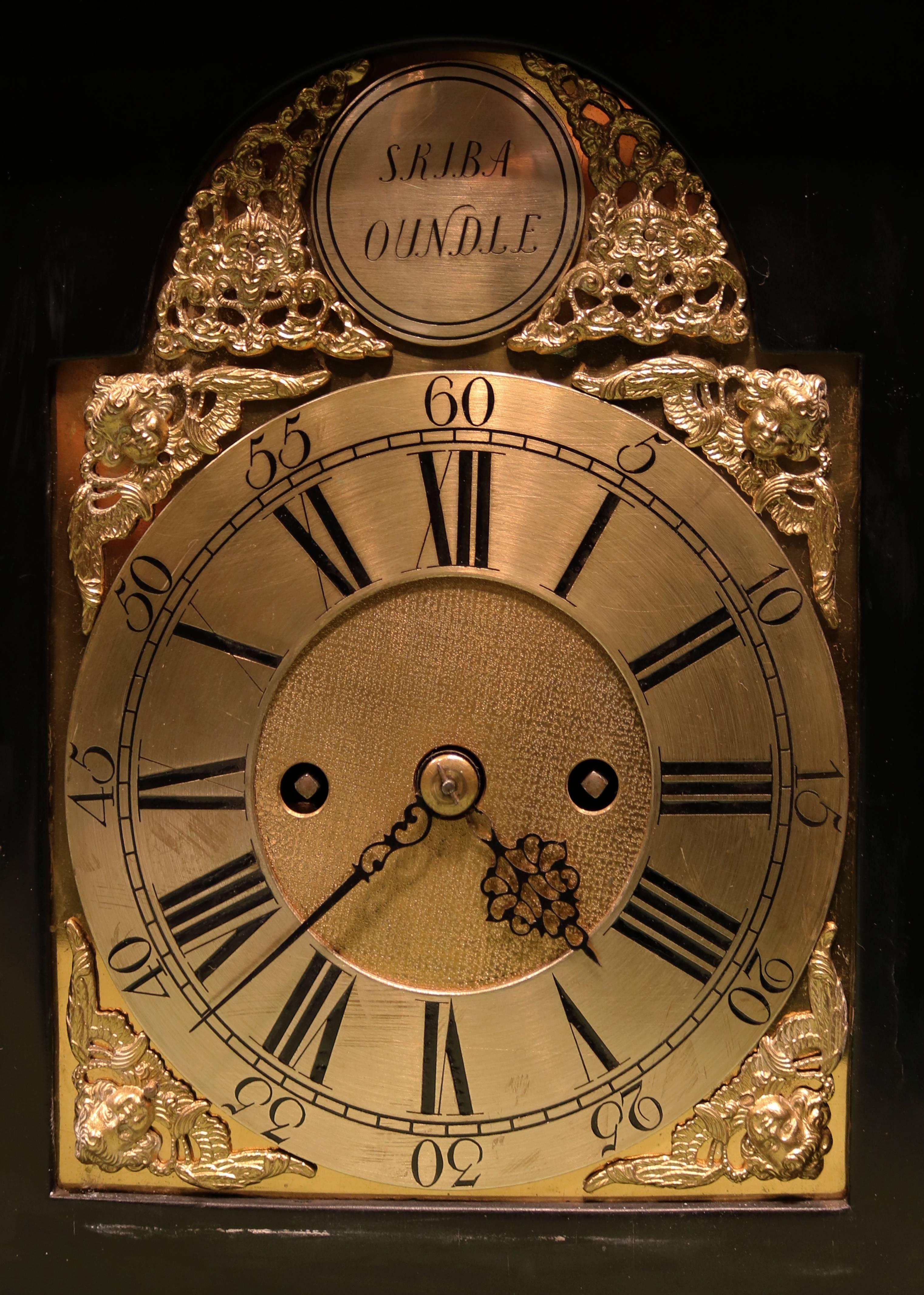 A mid-18th century bracket clock, having 8-day striking verge movement, the silvered dial signed ‘Skiba Oundle,’ contained in ebonized case with pierced brass mounts, bonnet top and brass carrying handle.