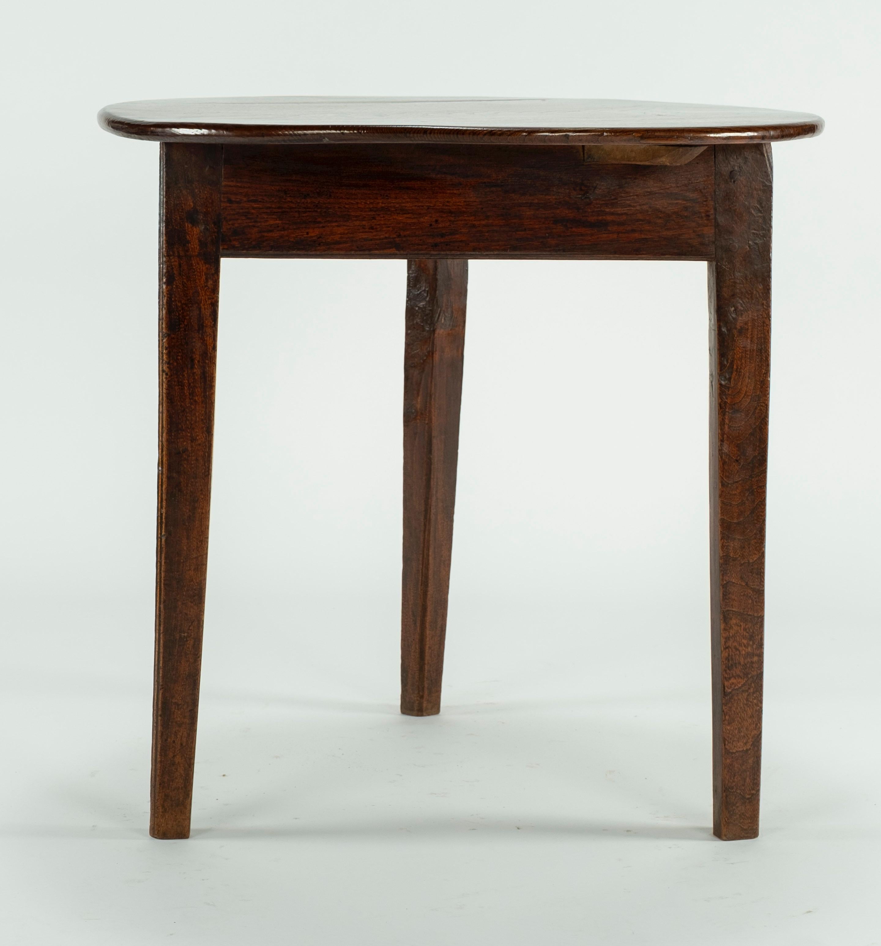 18th century elm cricket table with a flat apron and chamfered straight legs.