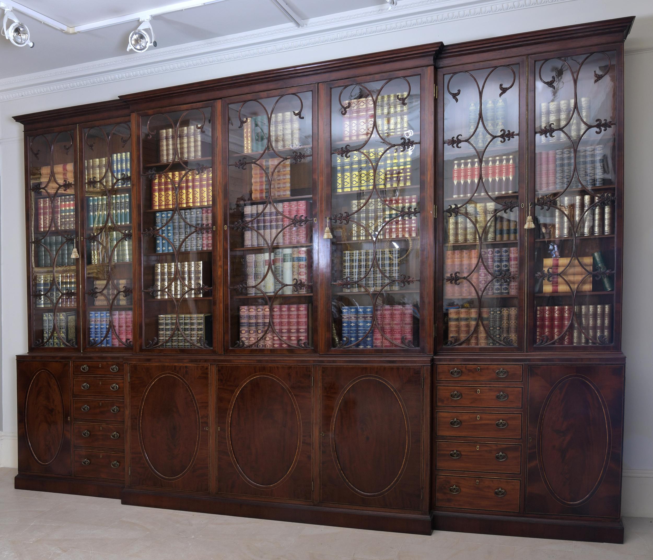 A magnificent George III period seven door breakfront library bookcase. Constructed in the finest quality figured mahogany, having a moulded cornice above seven astragal glazed doors enclosing adjustable shelves, the middle upper section having a
