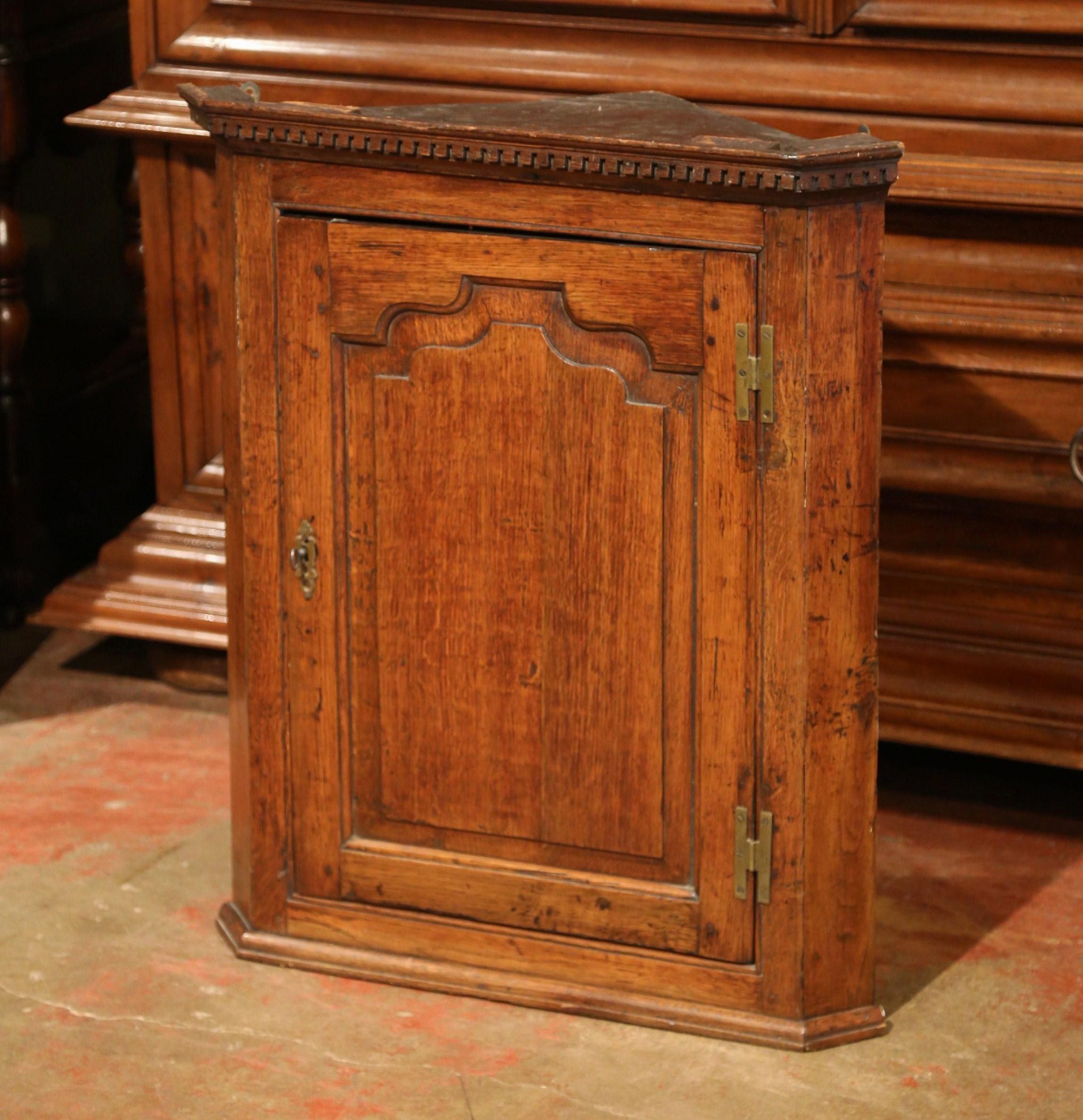 Decorate a breakfast room, a powder room or a master bath with this antique wall corner cabinet. This traditional, discrete cabinet easily fills up unused space, and can be used to store small items. Crafted in England, circa 1780, the corner piece