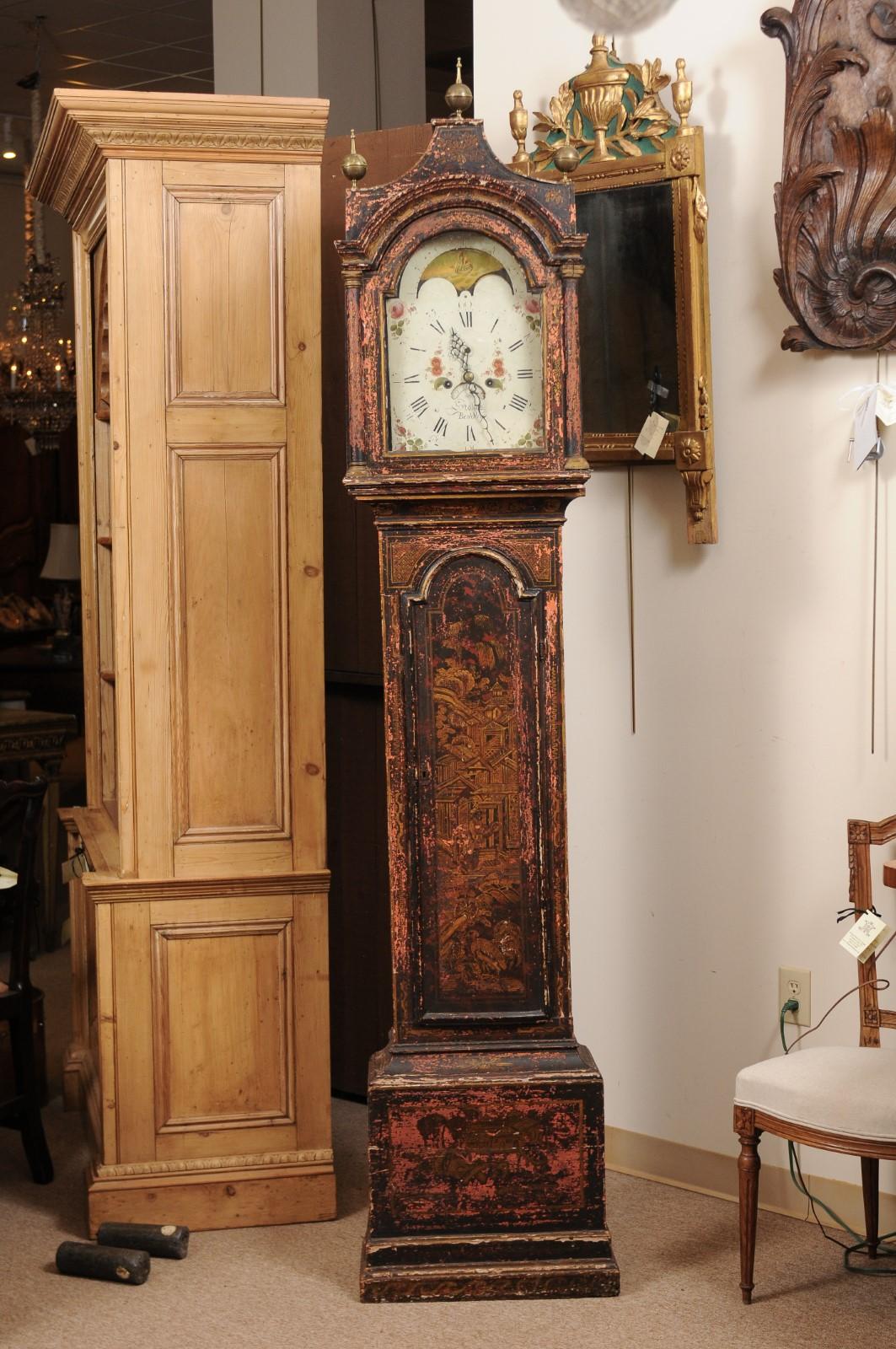 Black lacquered chinoiserie decorated long case clock in distressed finish with floral decorated painted face, 18th century England.