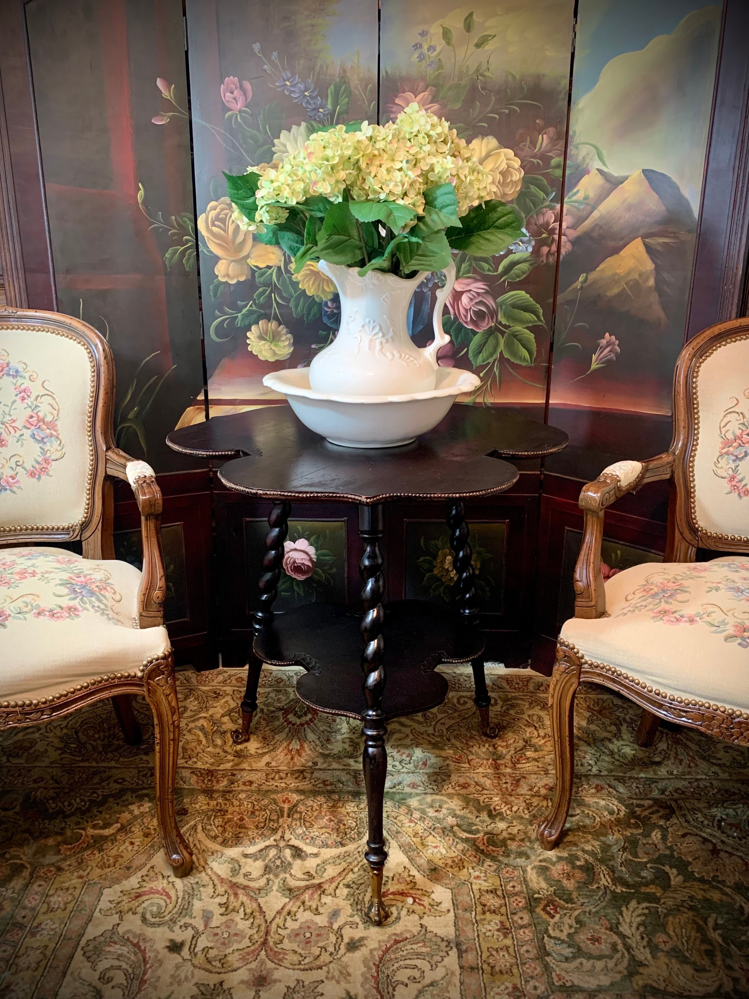 This rare antique cloverleaf garden table provides an elegant way to display eye-catching seasonal floral arrangements just as it originally found it’s place in the iconic English garden rooms of the 18th century. 

The spiral lathe-turned legs and