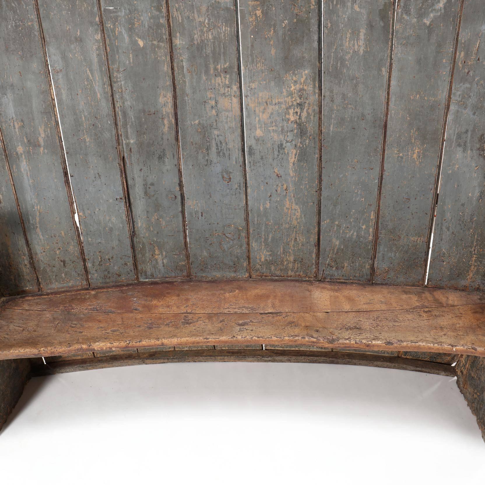Great 18th century old blue-grey painted wood settle with high concave back and seat, shaped arms with beautiful patina, probably was originally in an old 18th century English pub or inn.
