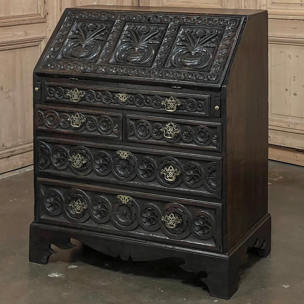18th Century English Country Secretary in Hand-Carved Oak is a superlative example of the design, conceived as a piece that takes up no more space than a chest of drawers, but can serve as a writing desk or student desk by simply dropping open the