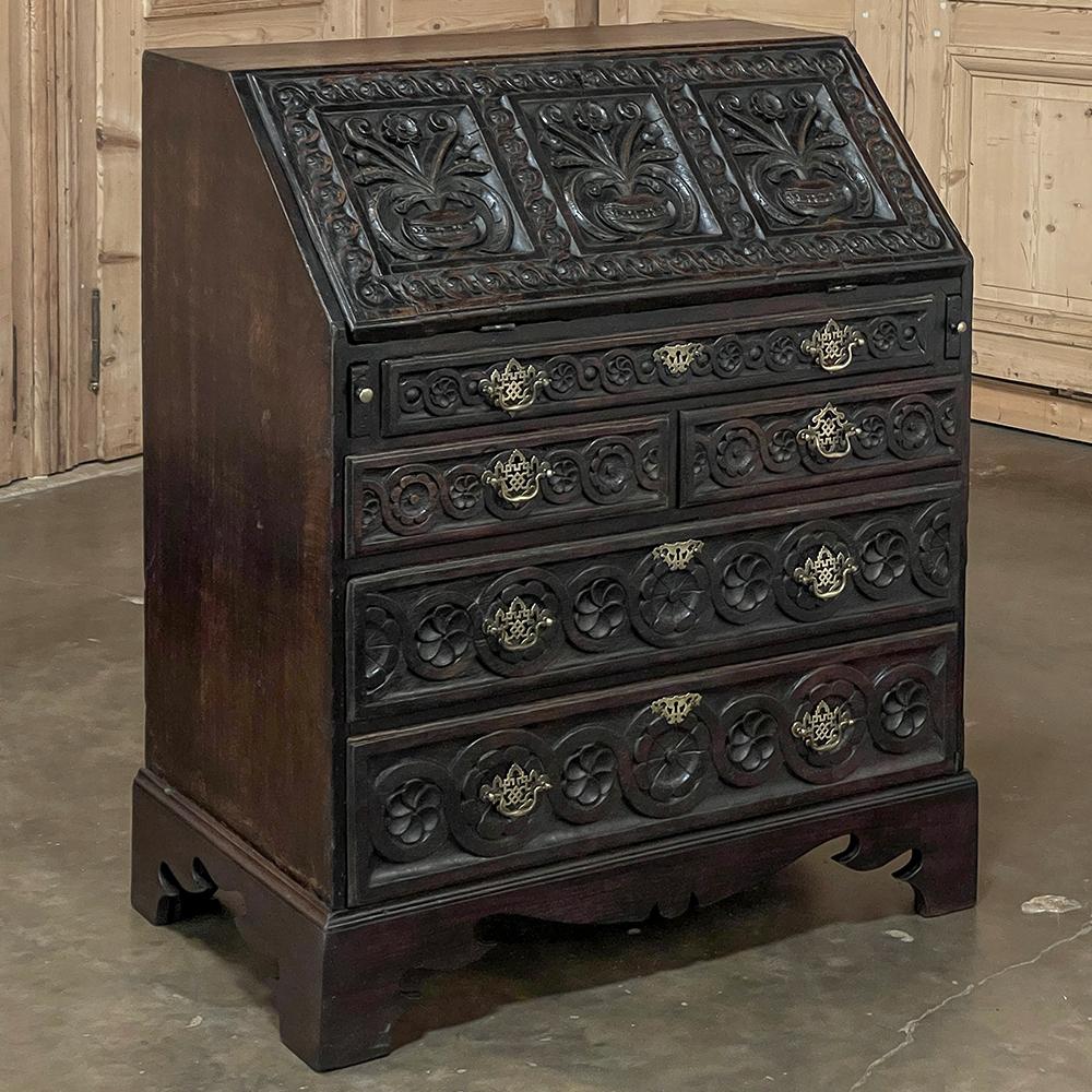 18th Century English Country Secretary in Hand-Carved Oak is a superlative example of the design, conceived as a piece that takes up no more space than a chest of drawers, but can serve as a writing desk or student desk by simply dropping open the