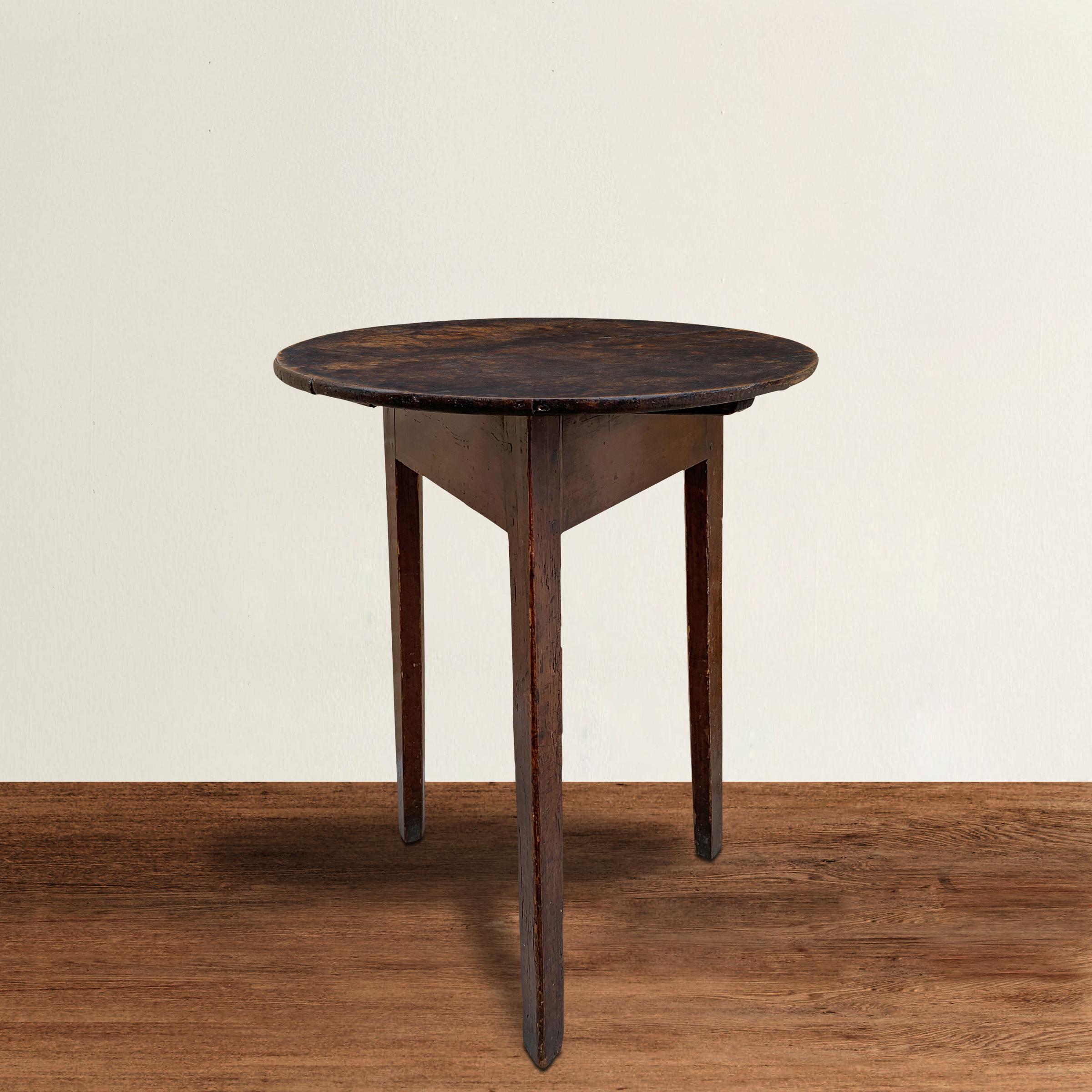 A simple 18th century English cricket table with clean lines, including three gently tapered legs pegged to a square apron, and a round top with a beautiful well-worn finish. Cricket tables were used in pubs, and specifically designed with three
