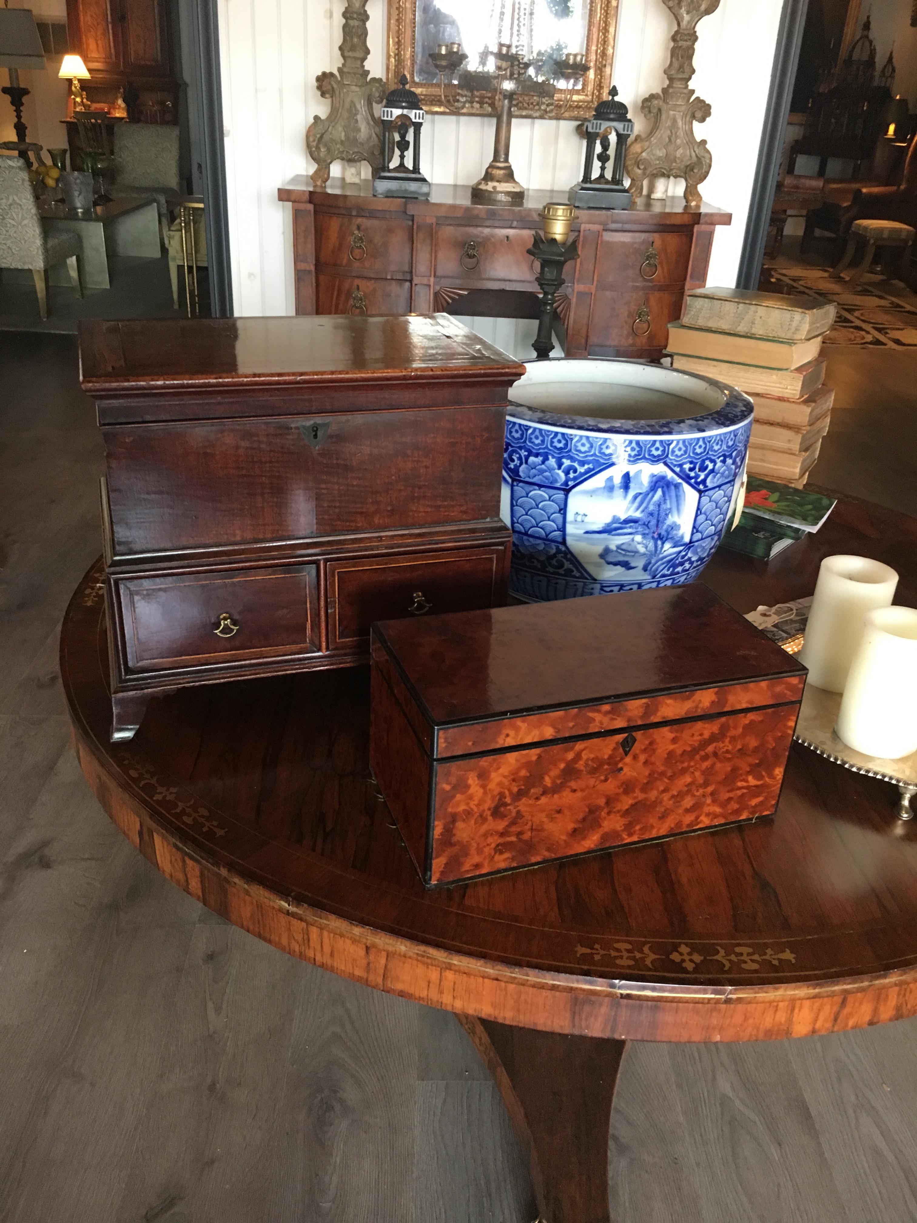 18th century English diminutive mahogany chest with satin wood banding. Top opens to an compartment over two drawers. Great color and patina. Can be used as a tabletop decoration or small side table.