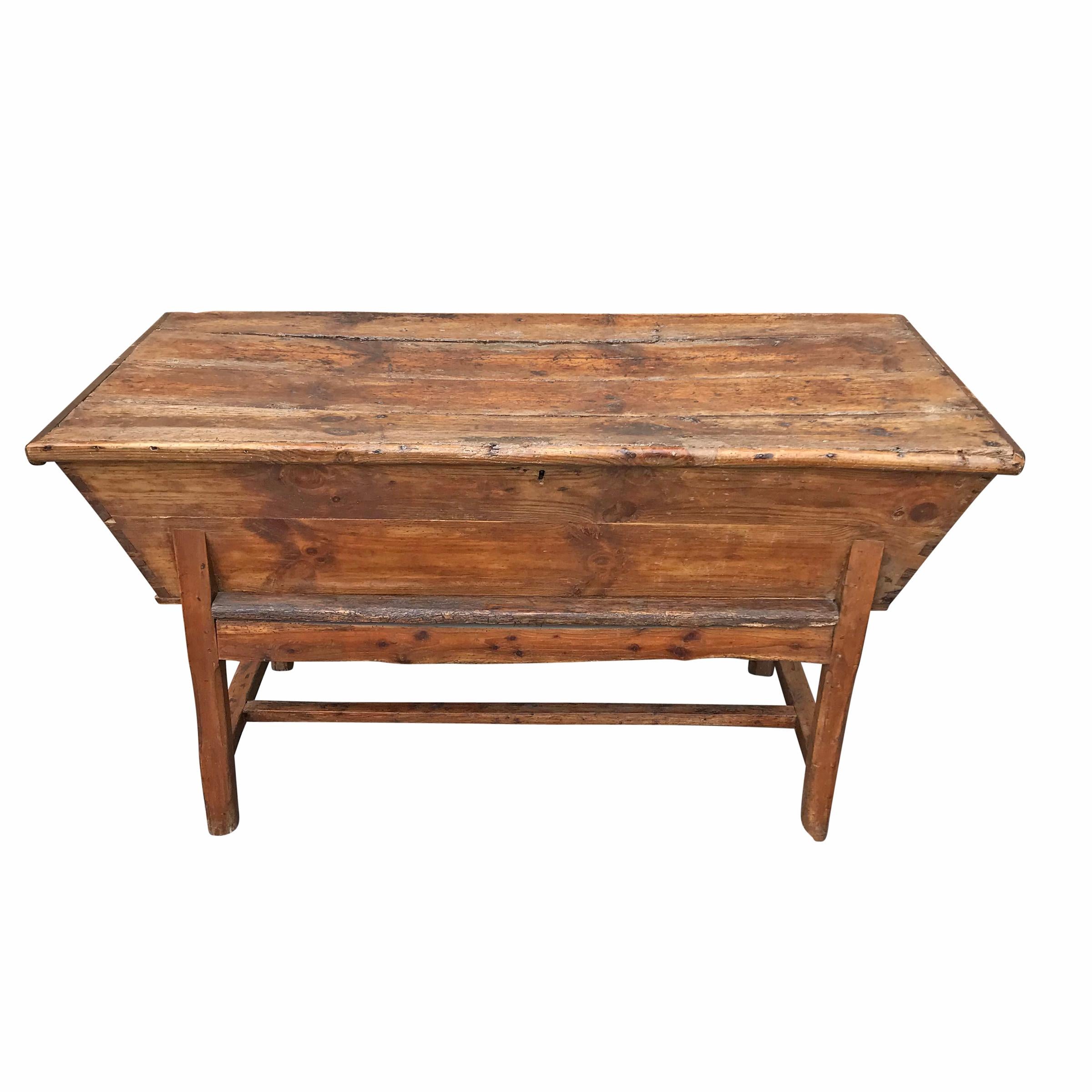 An extraordinary 18th century English elmwood dough proofing table with wonderfully worn and convex top, from centuries of use, that opens to reveal a large proofing chamber of dovetail construction and two wrought iron strap hinges. The legs are