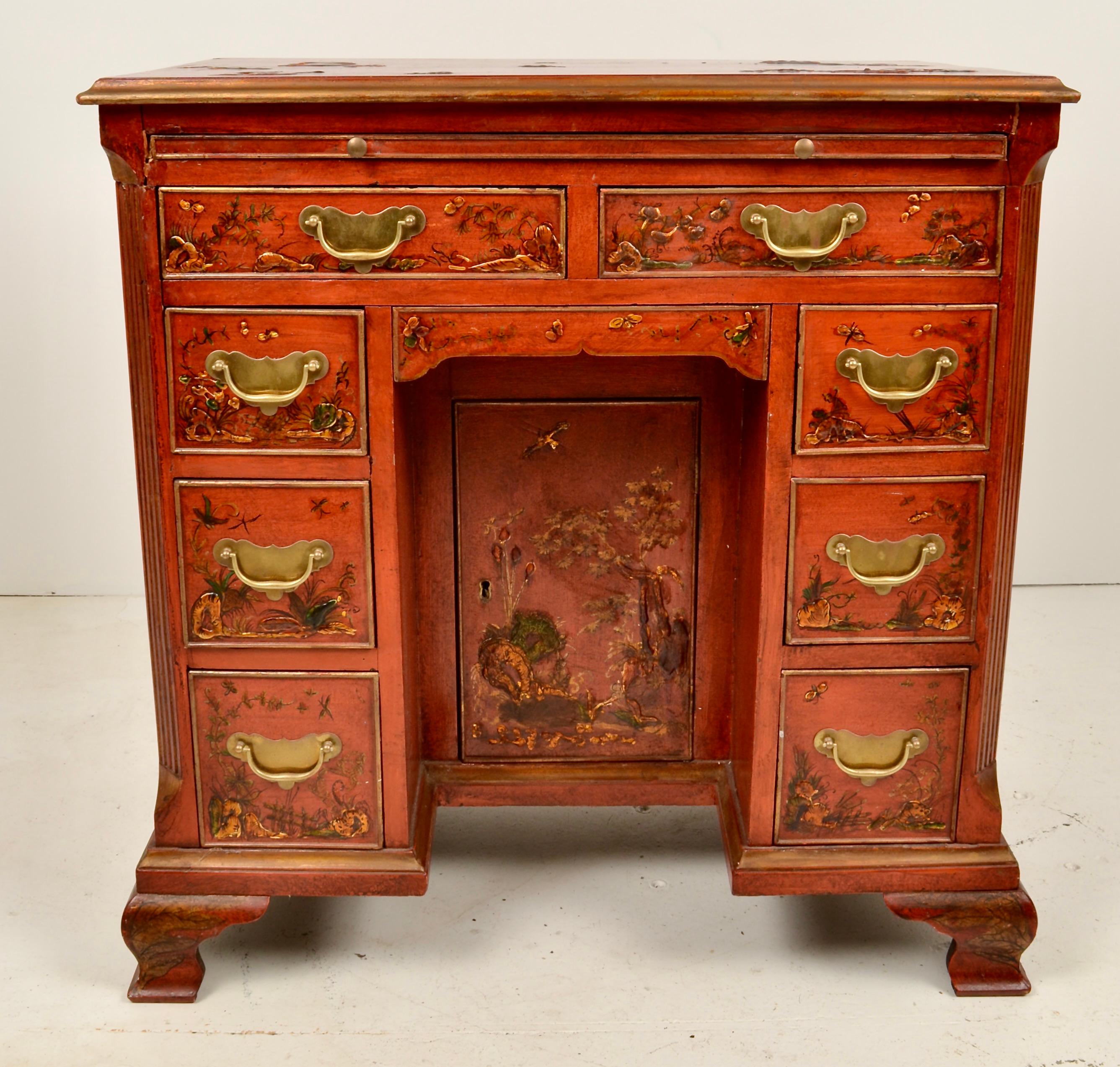 Lovely form on this 18th century desk with a beautiful chinoiserie finish added in the 19th century.  The color is remarkable with fine figured painting in the Chinese manner, accented with gilt. Featuring a center slide, eight drawers and a