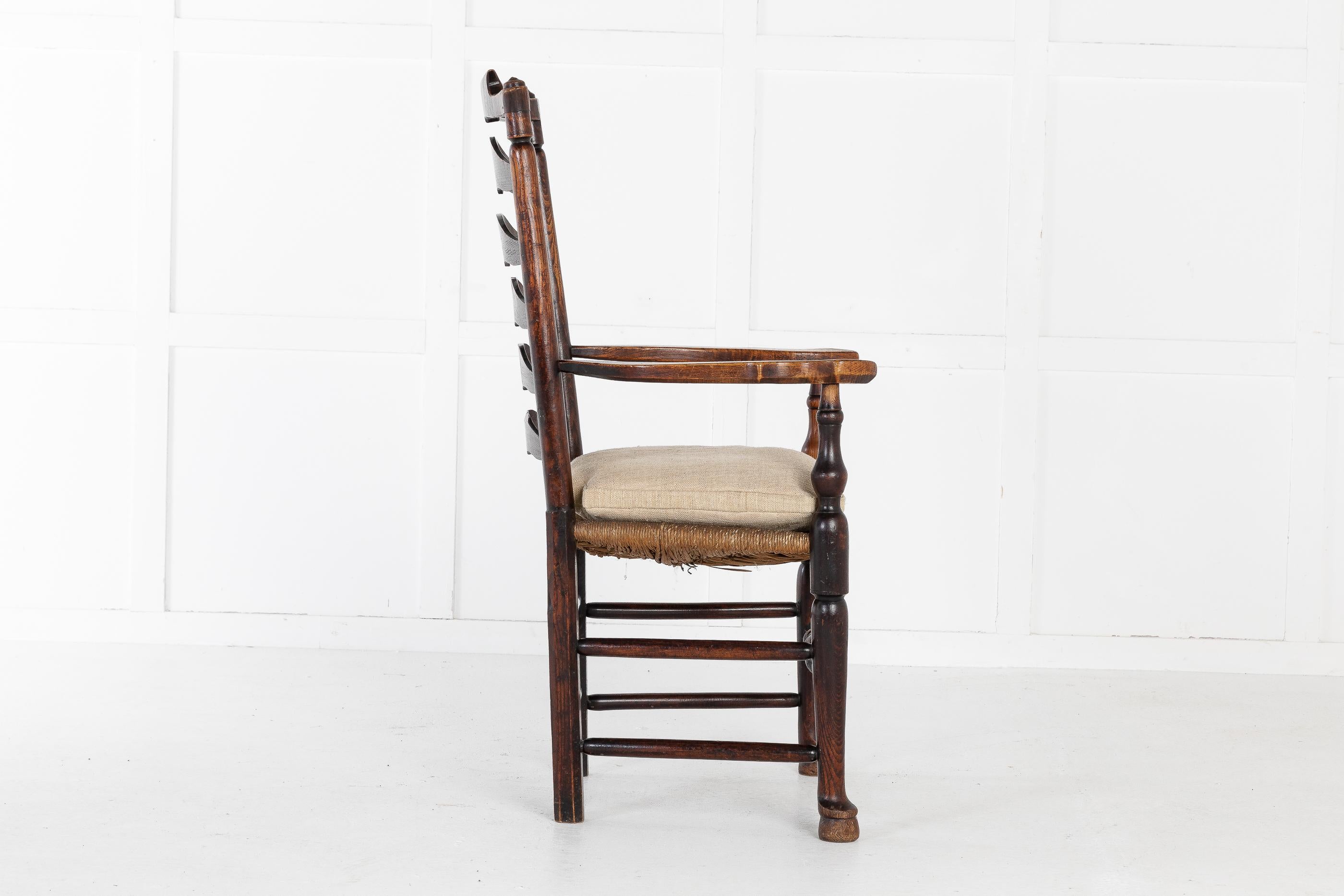 18th century English elm ladder-back carver chair. A good, large sized chair. The elm timber is a fabulous colour. There is slight damage to the rush protected by seat cushion.
Measures: Seat height 50cm
Seat depth 43cm.