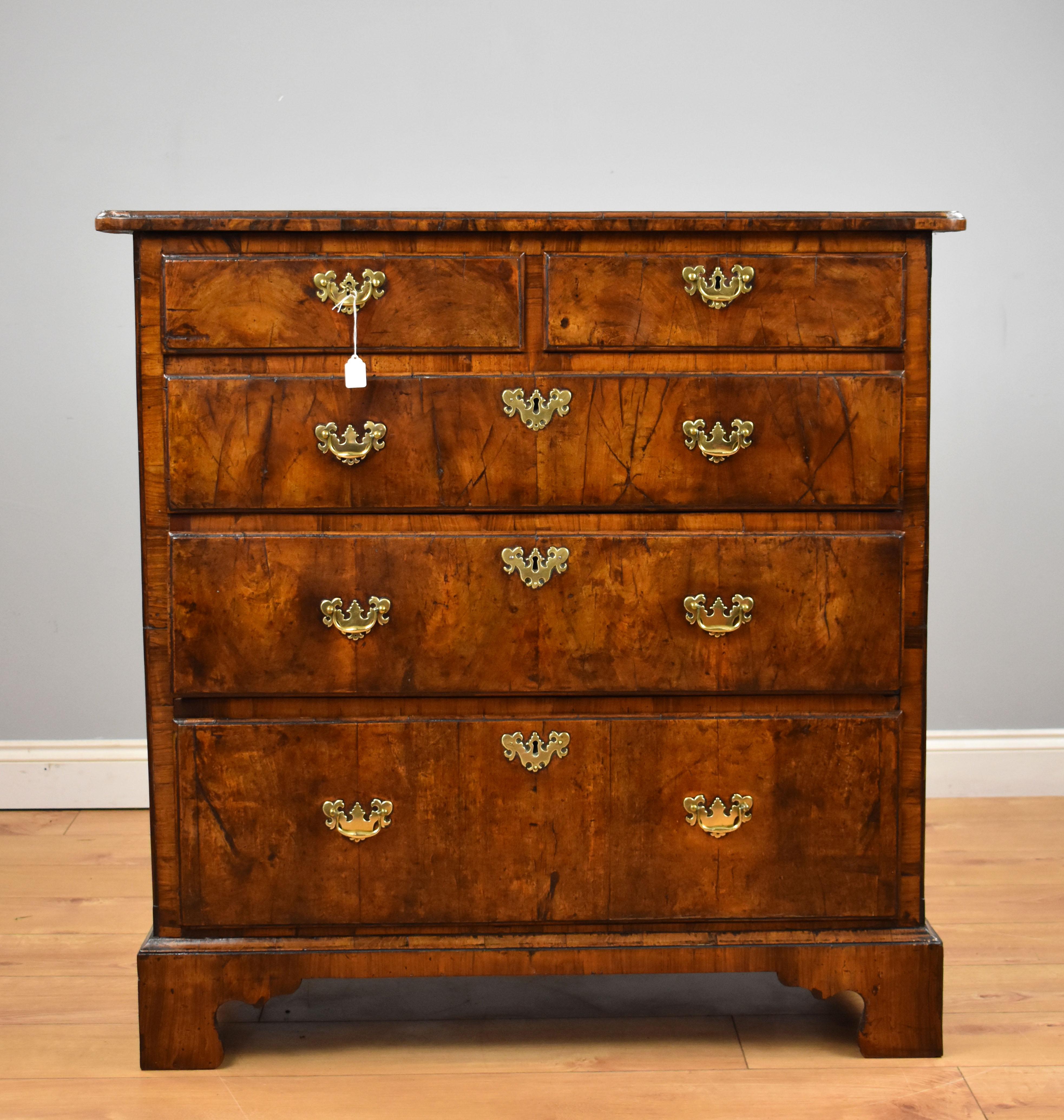 For sale is a good quality George II walnut chest of drawers, having an arrangement of five graduated drawers, two short over three long, raised on bracket feet. The chest is in good functional condition, showing wear commensurate with age and