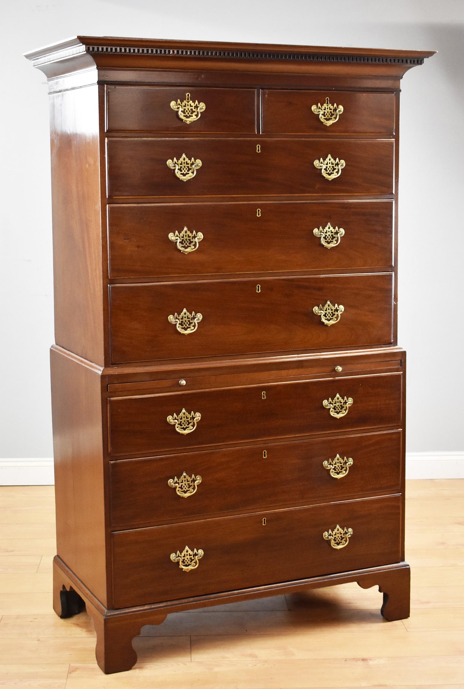 For sale is a good quality George III mahogany chest on chest, having a dentil moulded cornice over an arrangement of five graduated drawers, with two short drawers at the top and three long drawers below. The base has a brushing slide above a