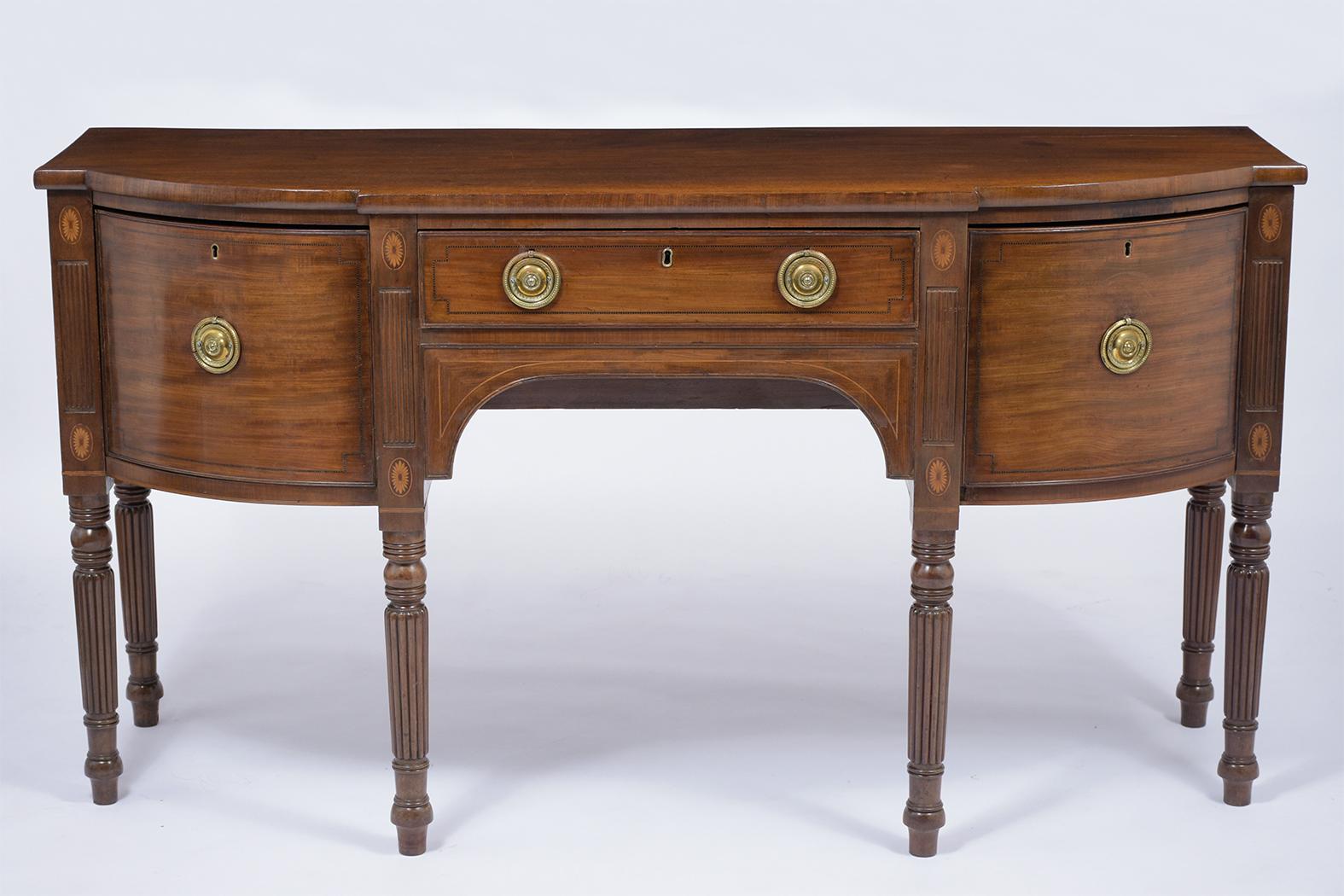 This late 18th-century English buffet handcrafted out of mahogany wood, this piece features its original mahogany color stain and has been freshly waxed and polished giving it a rich patina finish, solid design curved top two deep drawers a single