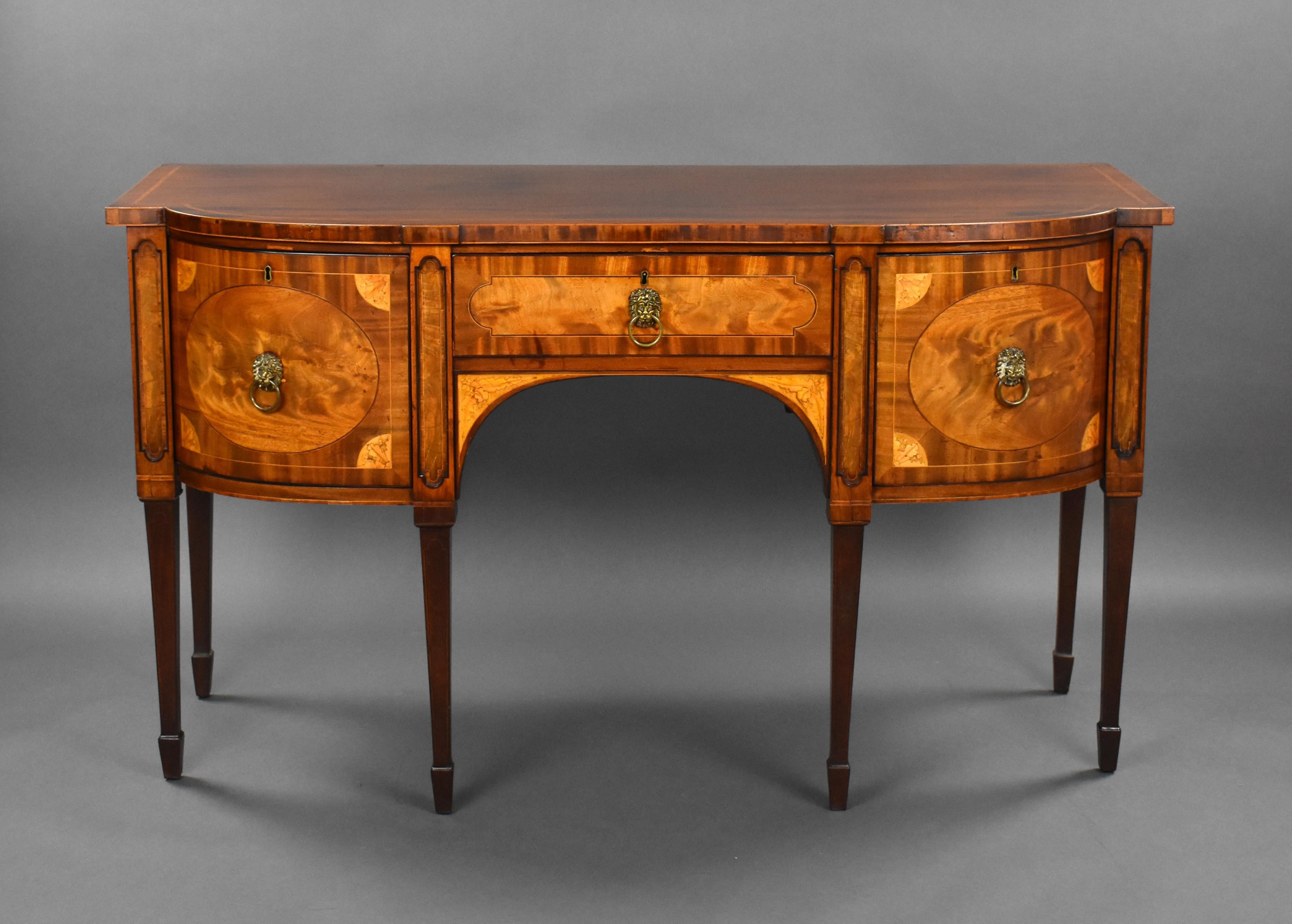 For sale is a good quality George III mahogany and satinwood cross banded bow front sideboard, circa 1790, in the manner of Thomas Sheraton, having a shaped slightly over sailing top above a single frieze drawers, one fitted with a celarette
