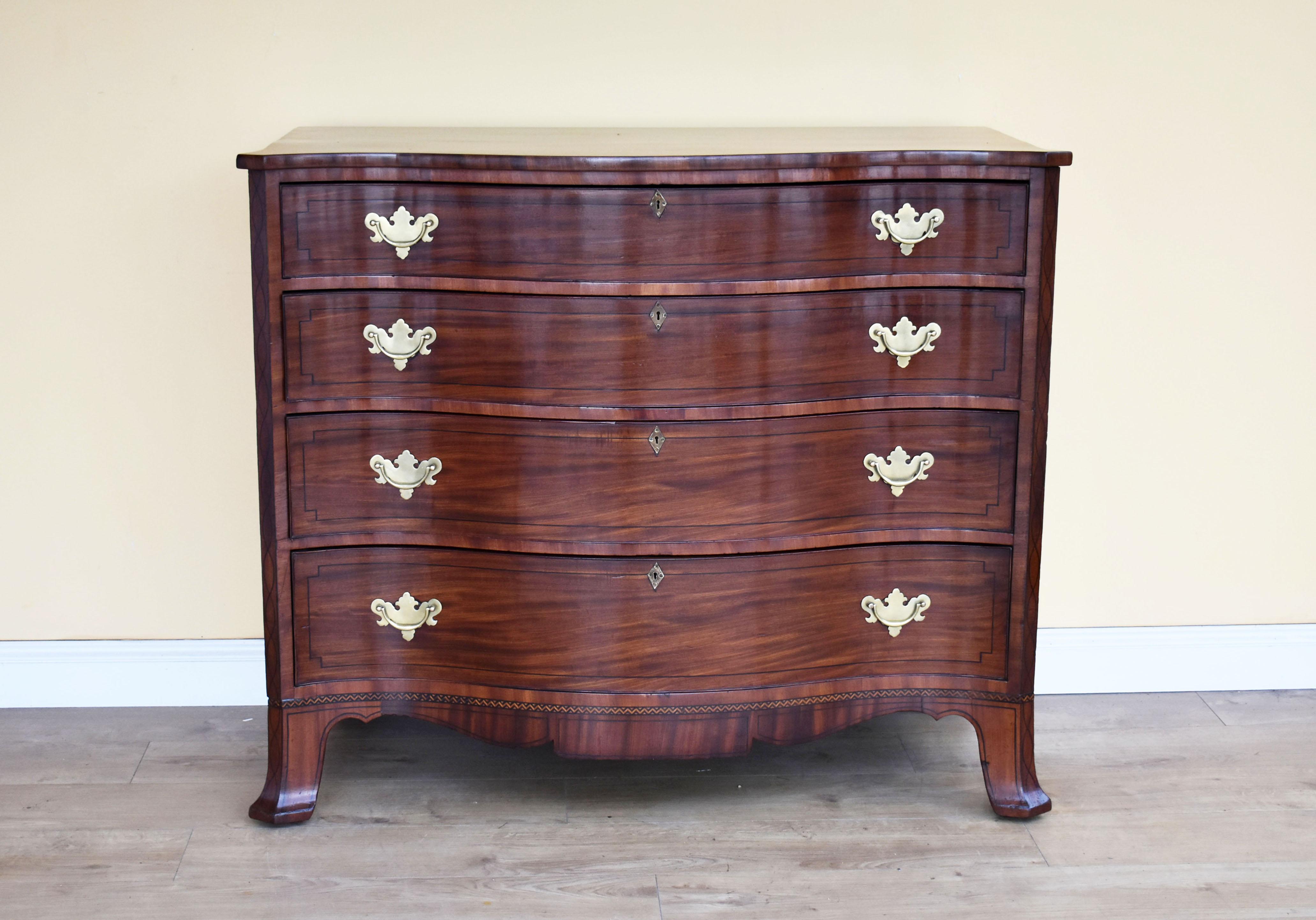 For sale is a good quality George III mahogany serpentine chest of drawers. The chest has four graduated drawers, each with brass handles and escutcheons also with ebony stringing inlay. The chest stands on serpentine feet and is in excellent