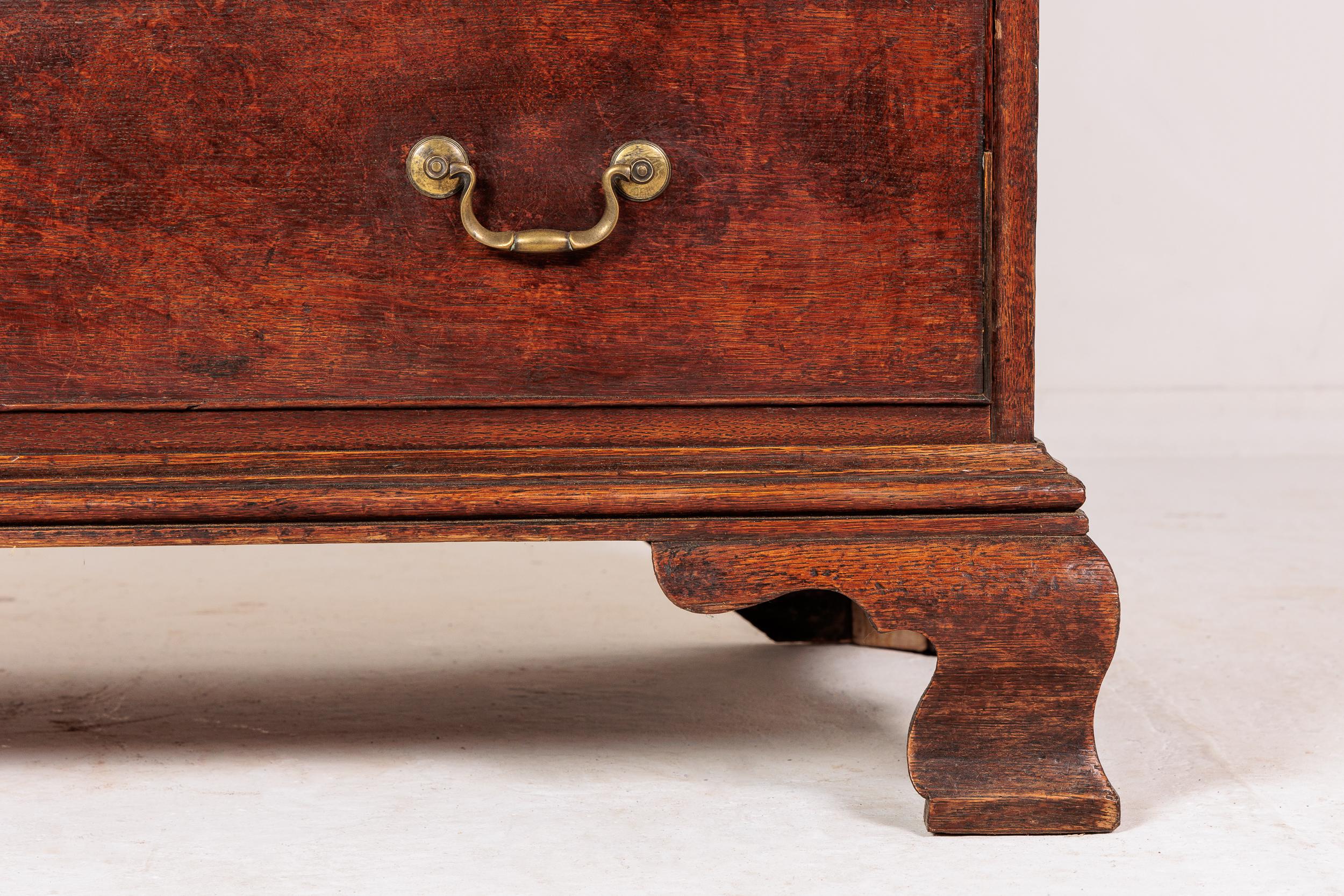 A small, well proportioned, 18th century English oak chest on chest. Having a top cornice with dentil moulding, canted corners and moulded frieze. Two short drawers at the top followed by three large, long drawers below, flanked by fluted canted