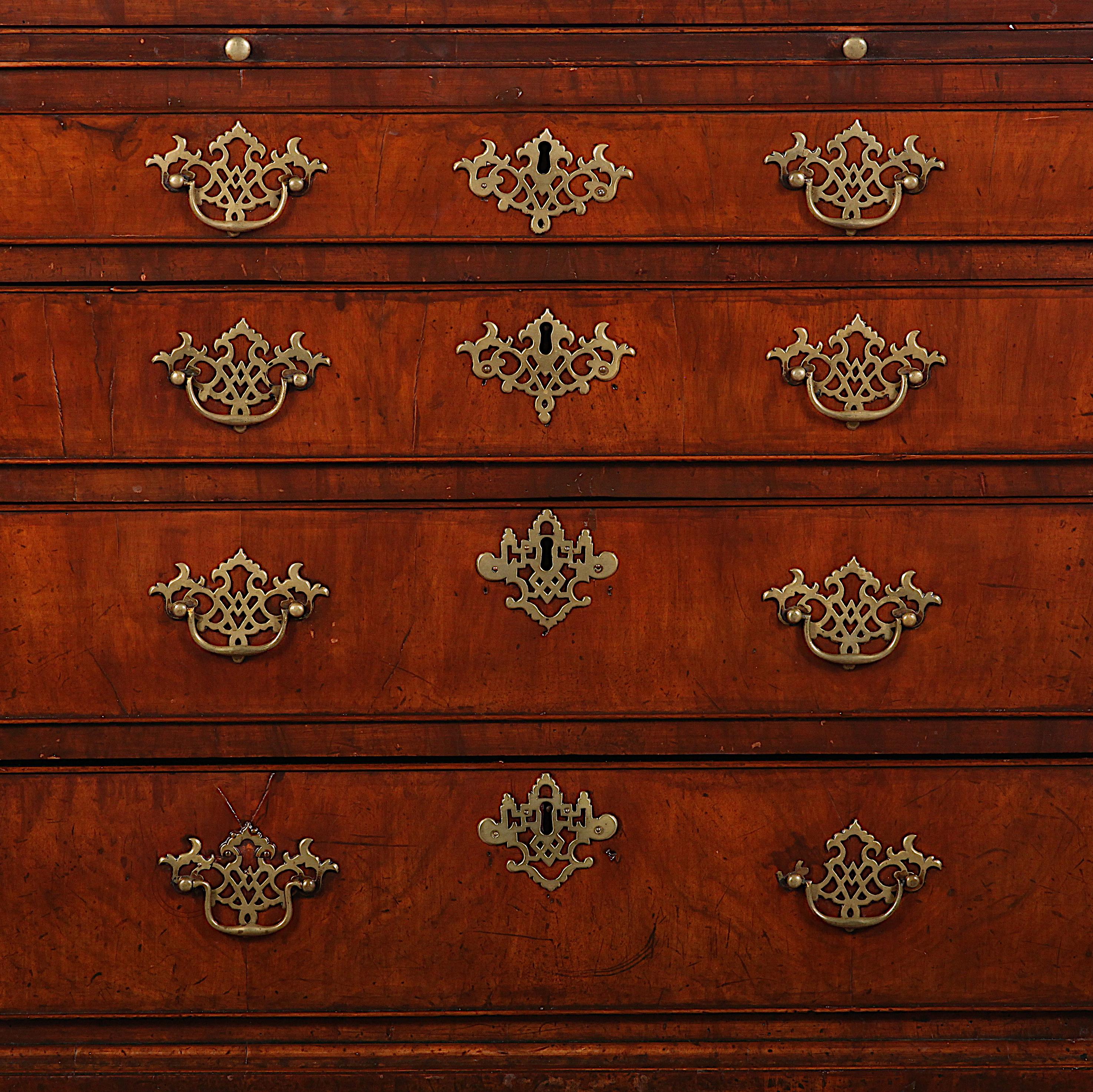18th Century English Georgian bachelors chest in walnut with four graduated drawers below a pull-out brushing slide, the whole raised on square bracket feet. Book-matched figured walnut veneered drawer fronts and top.