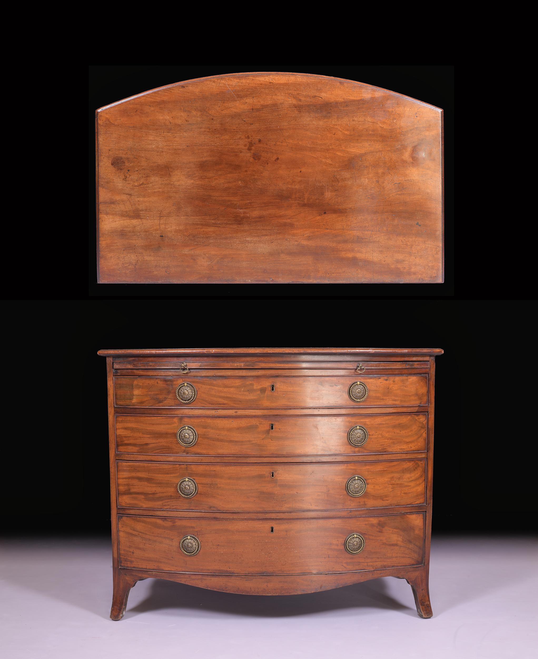 A fine antique Georgian mahogany bow front chest of drawers. The bow front top with figured mahogany above a slide and an arrangement of four long graduating drawers, each with decorative brass plates and drop handles. The mahogany bow front chest