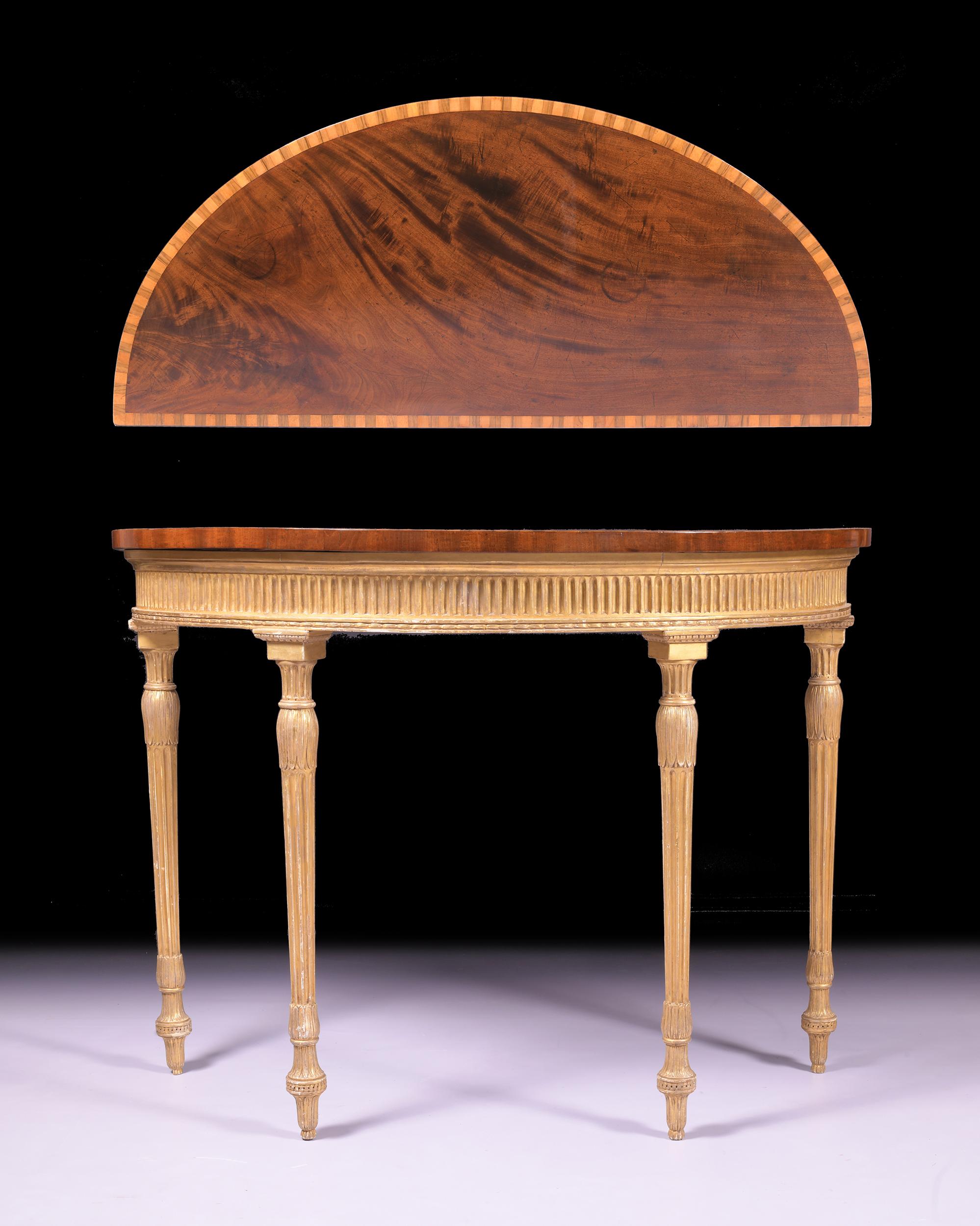 A fine George III console table in the Adam style, the demi-lune mahogany top crossbanded in various woods, above a moulded fluted frieze on lotus leaf carved and fluted tapering legs.

Circa 1790

English

Footnotes:

Pier tables such as