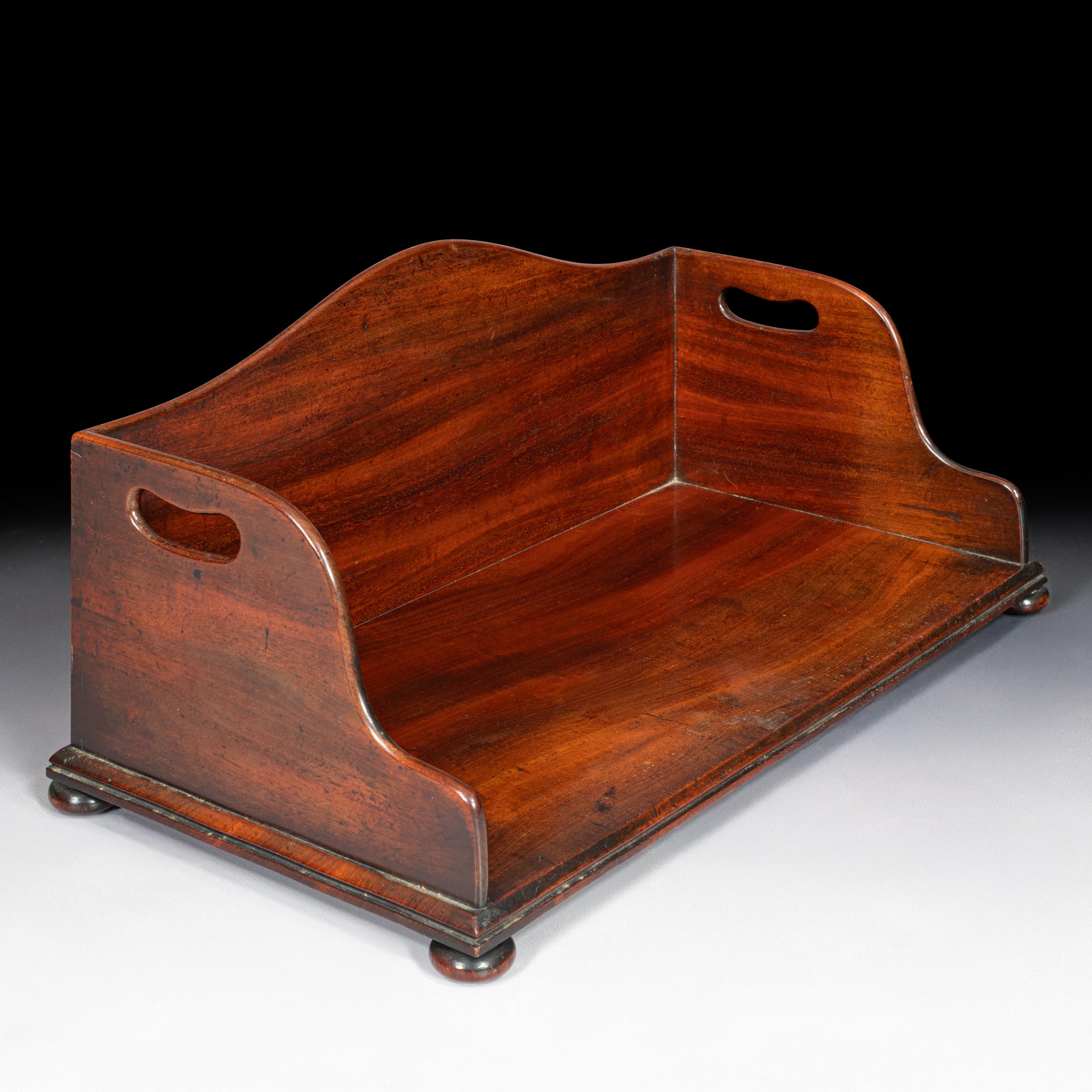 This is a beautifully crafted Georgian mahogany book or tray stand, designed with elegant simplicity and functionality in mind. Likely intended for use in a gentleman’s library or drawing room, it would have held folios, ledgers, or trays. Of