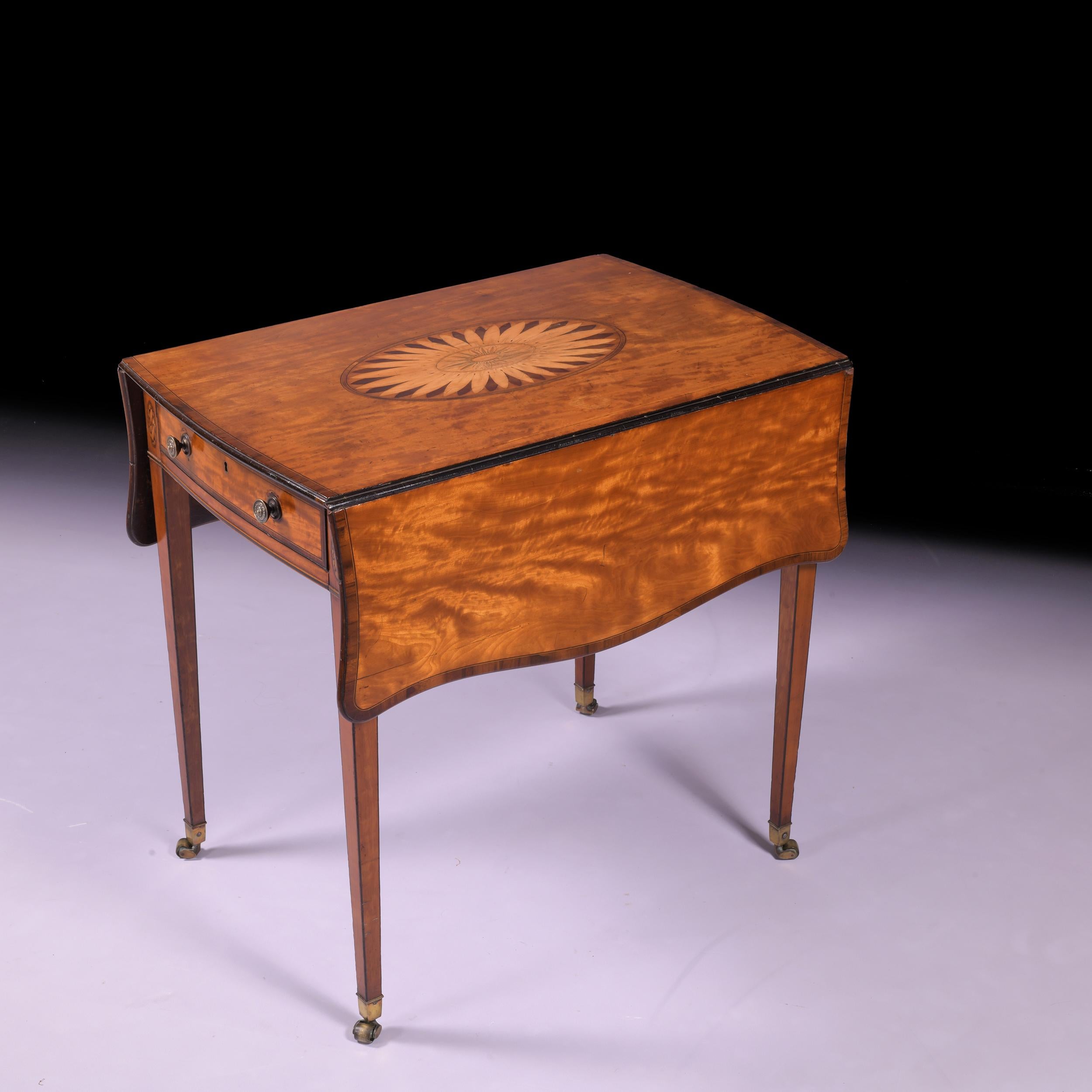 A very fine George III Satinwood Pembroke table, with twin serpentine drop leaves, moulded rim, the top with central oval patera above a single frieze drawer on channelled tapering legs on castors

Circa 1790

English

Dimensions:

H: 27.95 in / 71