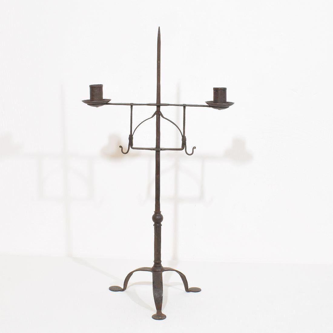 Very pure and beautiful hand forged iron candleholder, England, circa 1700-1800. Despite of its age in a very good condition. Candleholder can be adjusted in height.