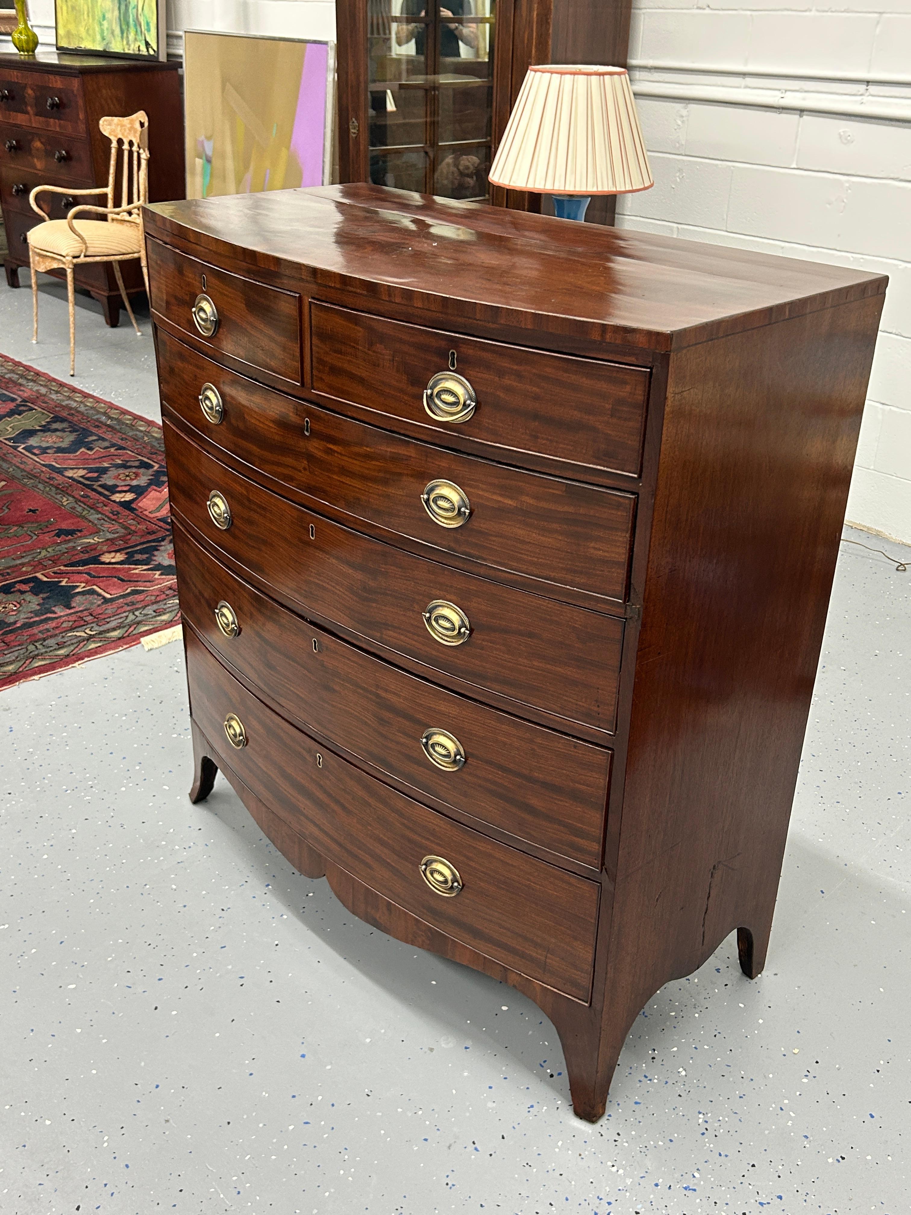 Presenting a timeless treasure from the 19th Century: an exquisite English Hepplewhite Chest of Drawers that effortlessly marries beauty and functionality. This remarkable piece showcases the elegance of the Hepplewhite style, adorned with features