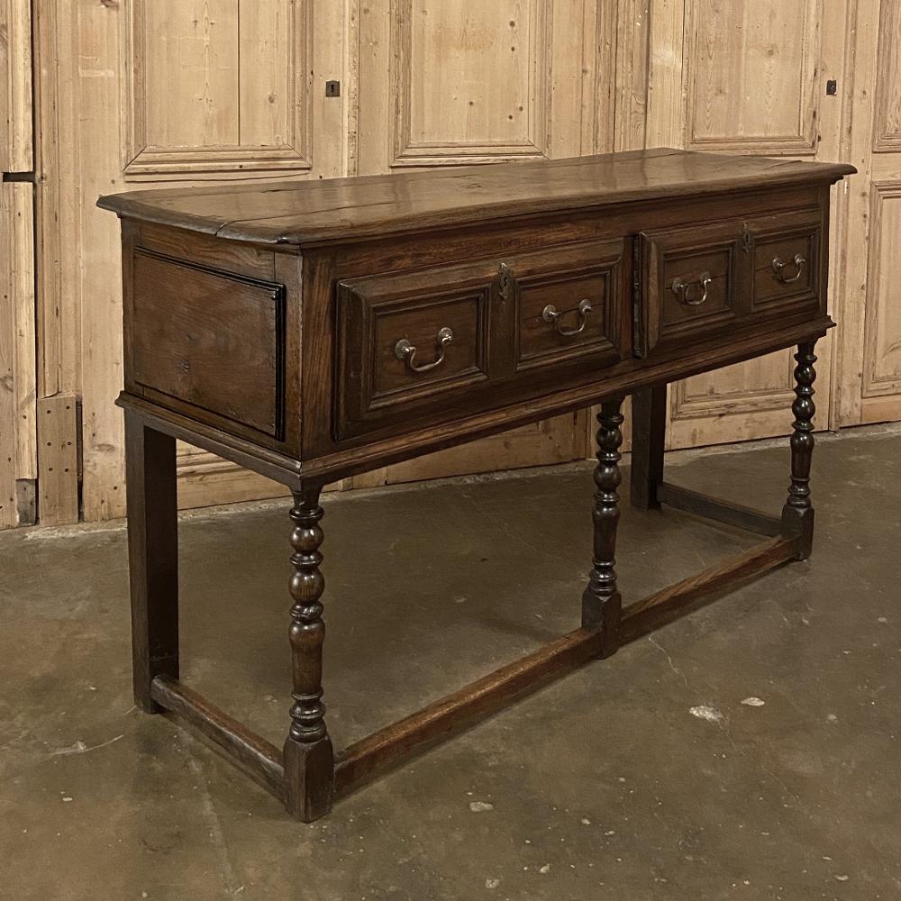 18th century English Jacobean sideboard is a timeless ode to the rural craftsman, who used simple tools to create sturdy, attractive yet functional furniture that literally lasts for centuries! This example, rendered from old-growth oak, features