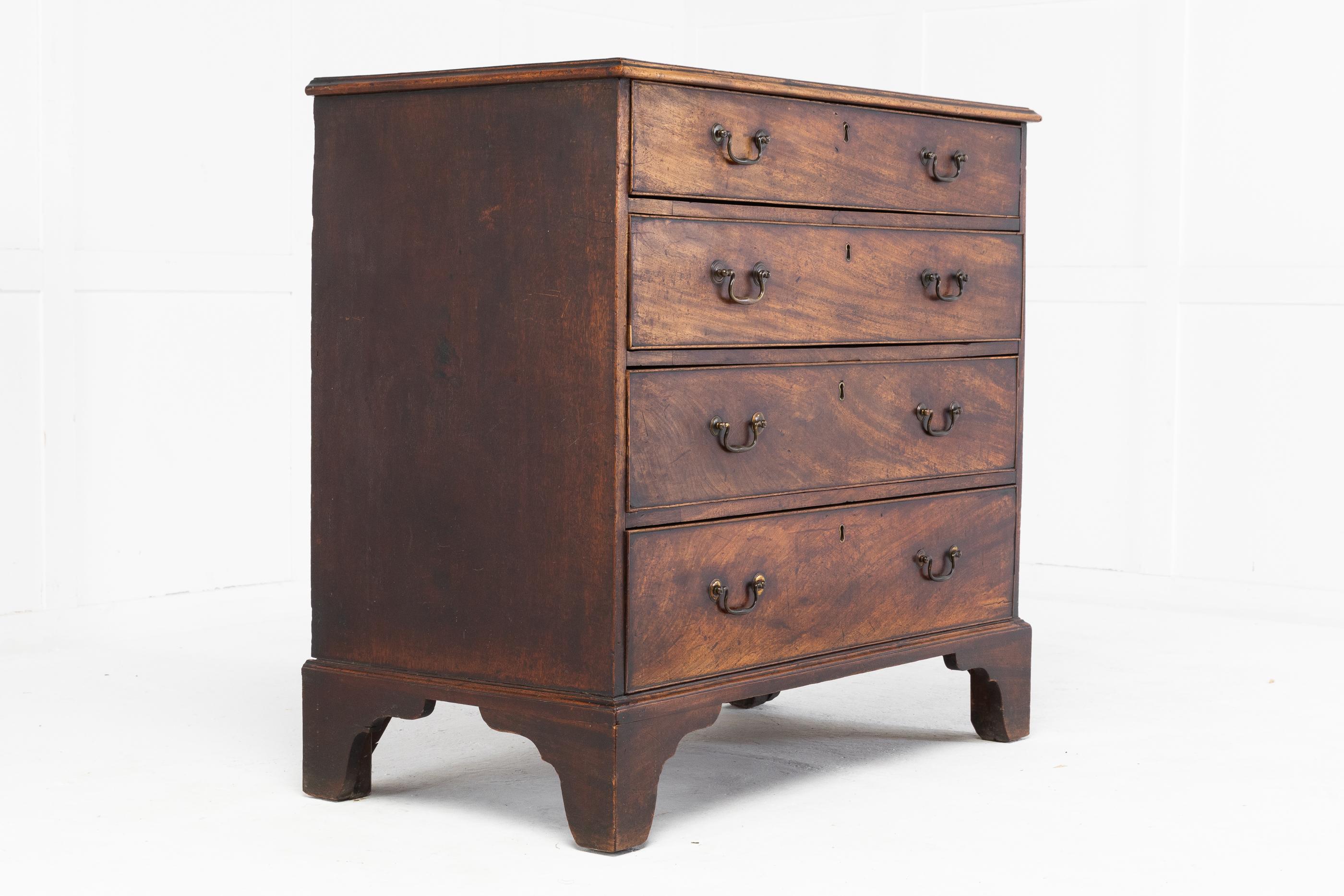 18th century English mahogany chest of drawers. In excellent original condition with original handles and nice untouched, dry colour. Having four graduating drawers and standing on shaped bracket feet.
 