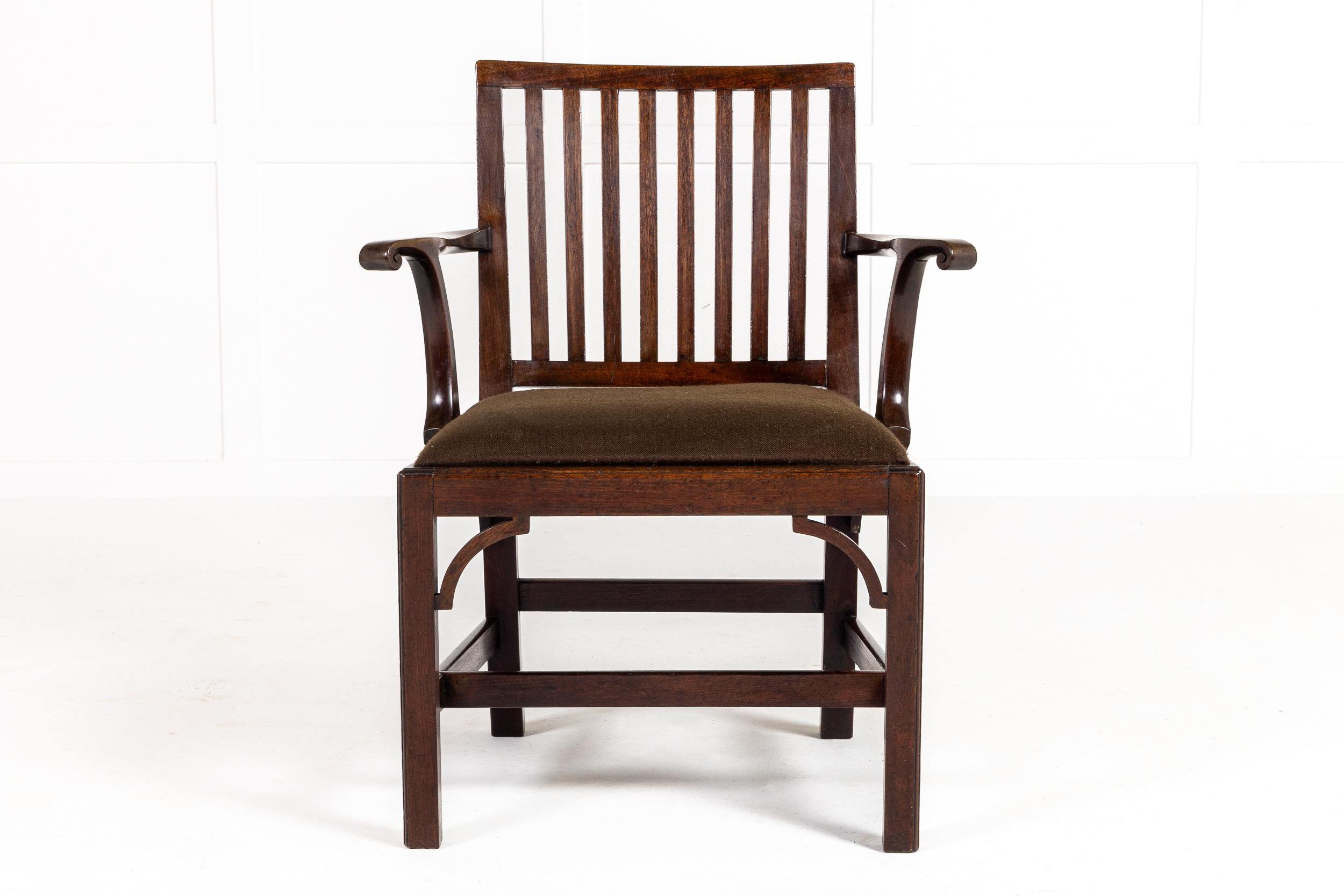 An 18th Century English Mahogany Armchair/Elbow Chair with Rectangular Splat Back.

This piece is clearly a fusion of different styles, having outscrolling arms, typical of those of the George I/II period, and fretwork brackets to the front legs