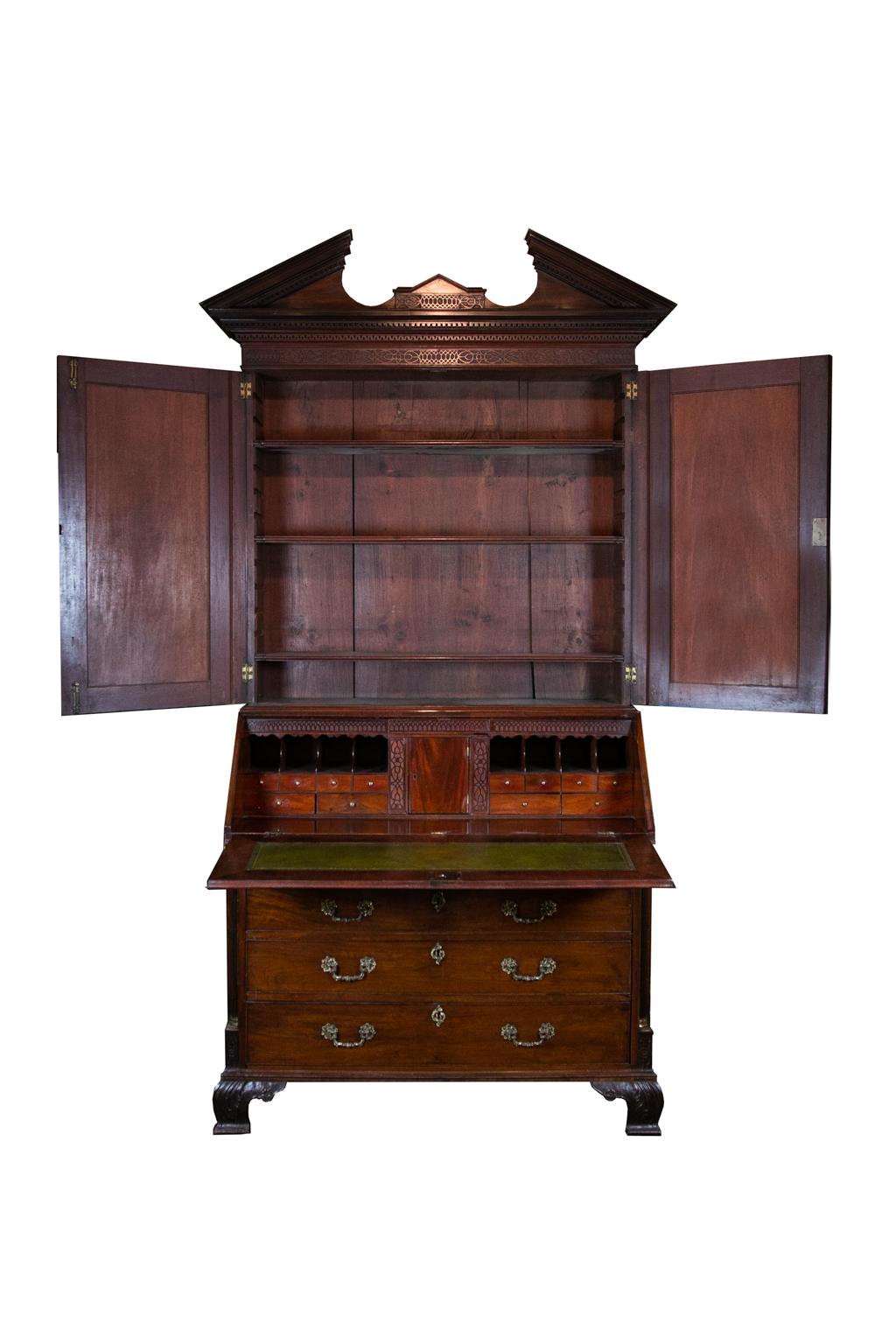 18th century English mahogany Secretary, with the frieze having blind fretwork. The cornice has dental molding and wall of Troy molding. The doors have stylized scallop shell quarter panels flanked by fluted quarter columns with high Corinthian