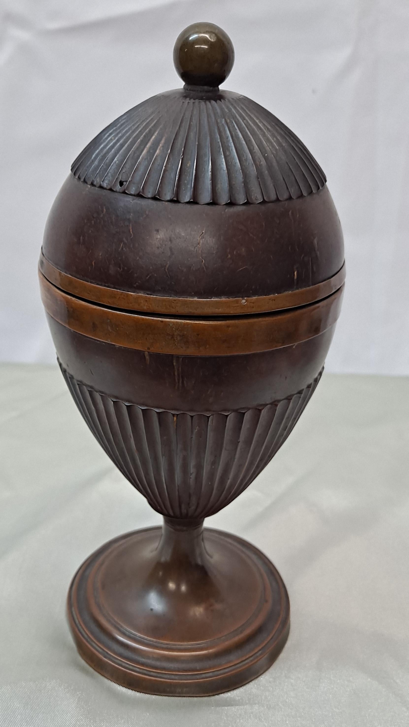 English egg shaped carved mahogany tea caddy, circa 1790.