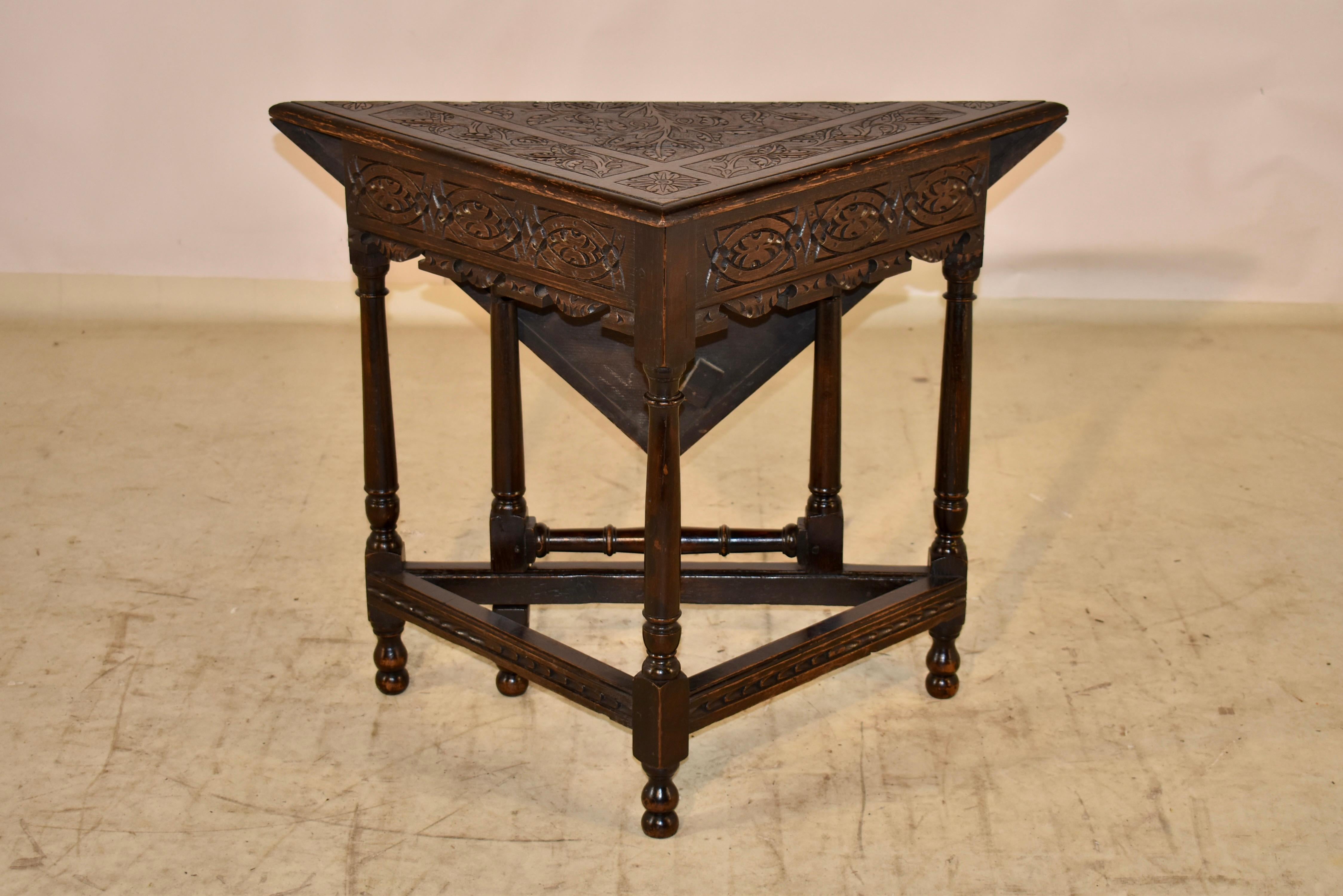 18th century English oak handkerchief table with a beveled edge around the top, surrounding a glorious top, which has all original hand carved decoration.  The apron is scalloped and hand carved decorated, and the table is supported on hand turned