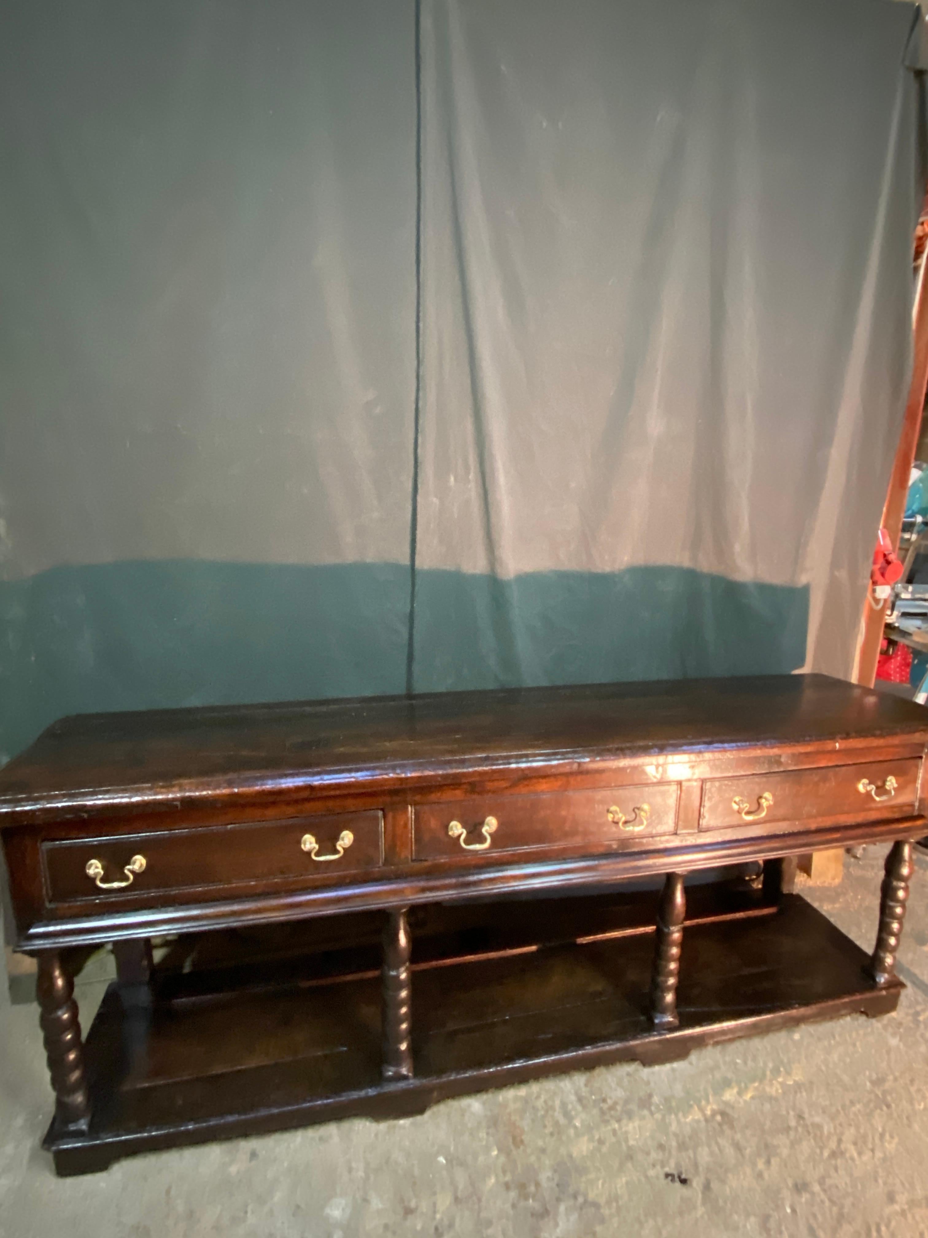 Magnificent English oak console sideboard from the 18th century opening with three drawers very nice base original brass hardware wonderful patina no restoration, immaculate condition.