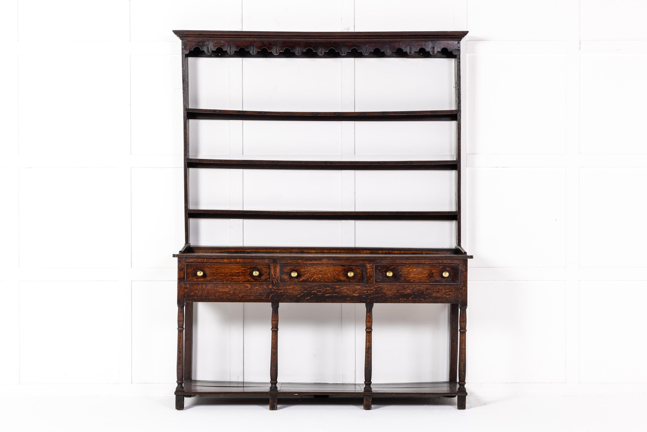 A Fine 18th Century English Oak Dresser of Desirable Small Size and Excellent Colour and Patination.

This lovely dresser employs a variety of interesting mouldings and details that make it very unusual and a sophisticated example of its kind.
