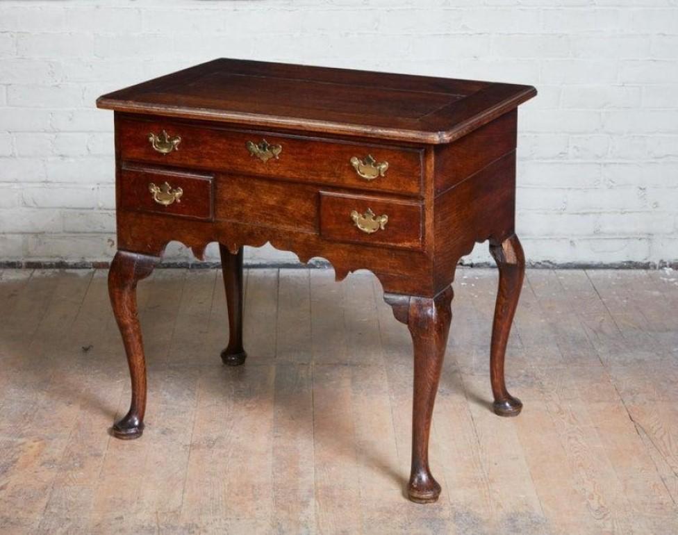 Good 18th century George I period oak lowboy having shaped and molded top with mitered breadboard top having reentrant 