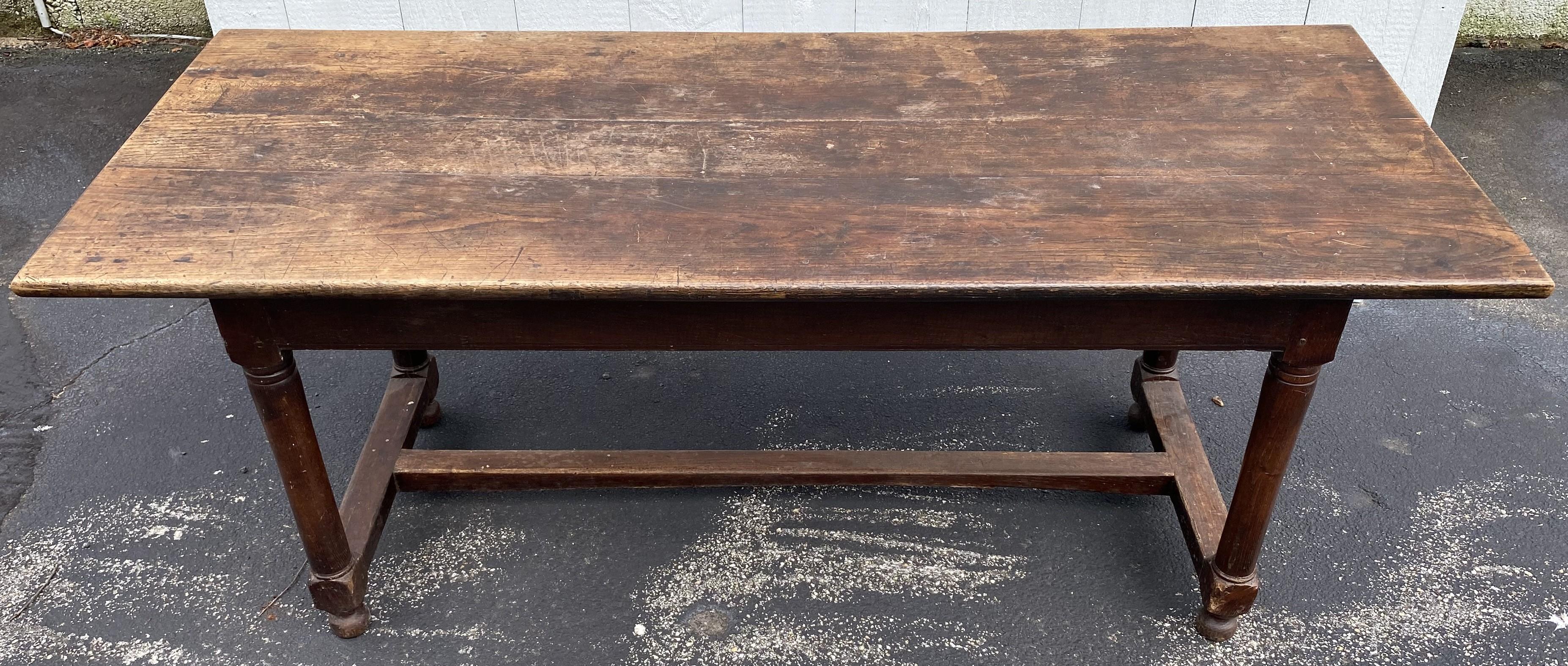 A fine example of an English rectangular oak dining or refectory table with H form stretcher base with bun feet. Dates to the 18th century with great overall patina, some surface wear and scratches, edge wear, minor imperfections and a few surface