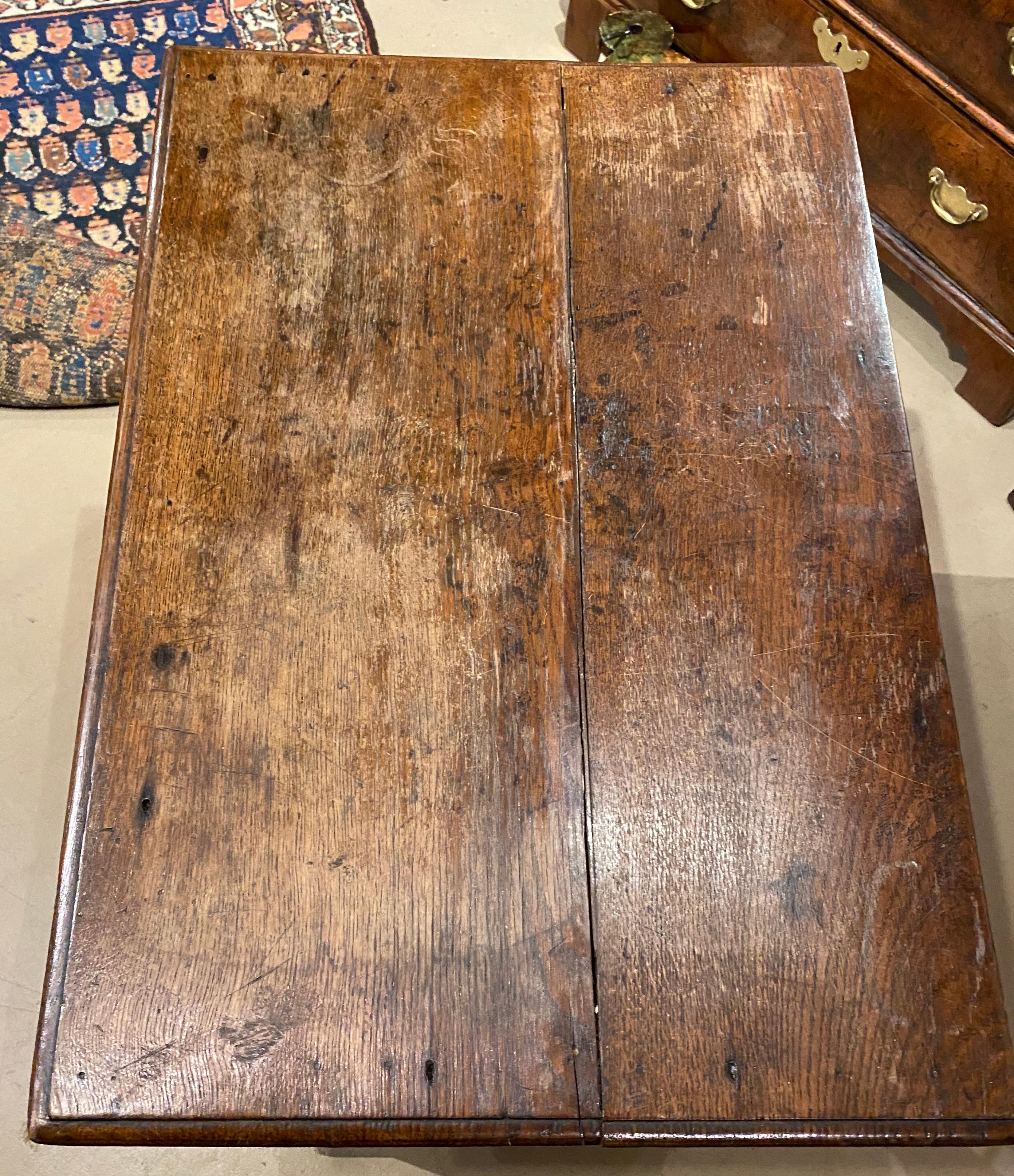 A nice example of a small size oak chest with molded edge rectangular top in a two over two configuration with brass drop pulls, dating to 18th century England. Very good overall condition, with some surface discoloration and finish wear, drawer