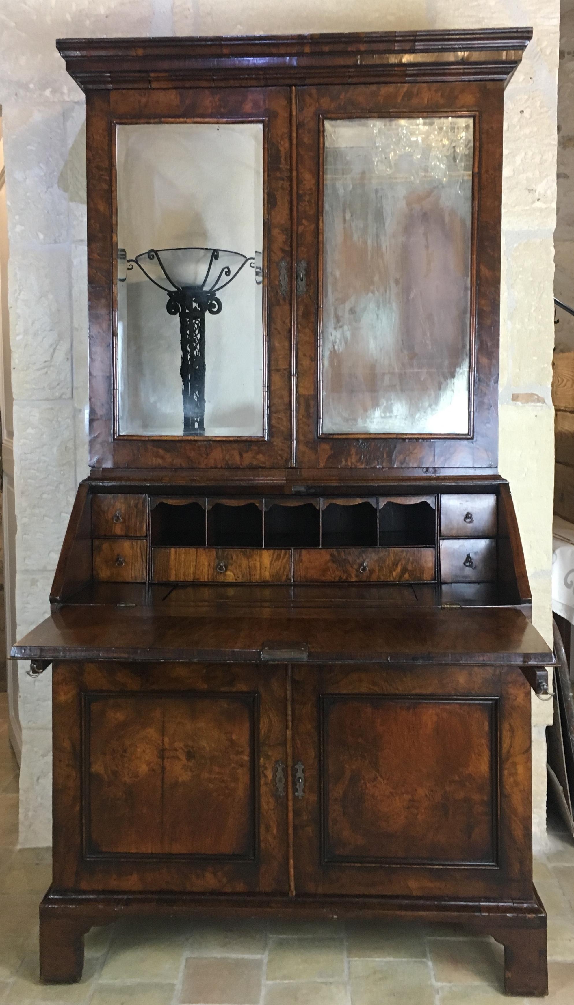 A fine 18th century English Queen Anne-period furnishings such as this walnut secretary are incredibly rare and important examples of English cabinetmaking, all original. This secretary is of the most outstanding calibre, boasting desirable double